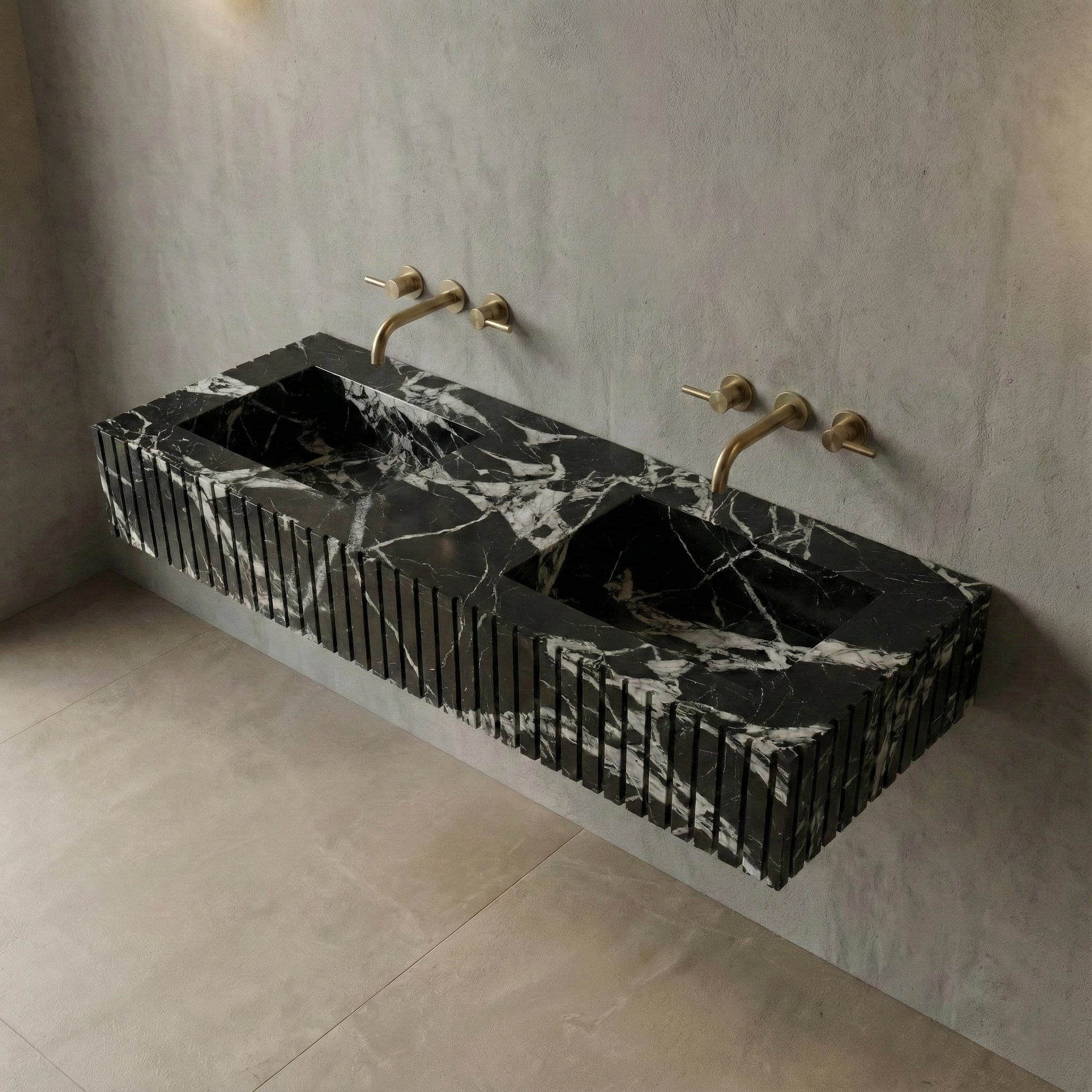 High-angle view of a floating Grand Antique marble double sink featuring a custom fluted apron and sleek integrated basins, accented by brushed gold wall-mounted faucets.