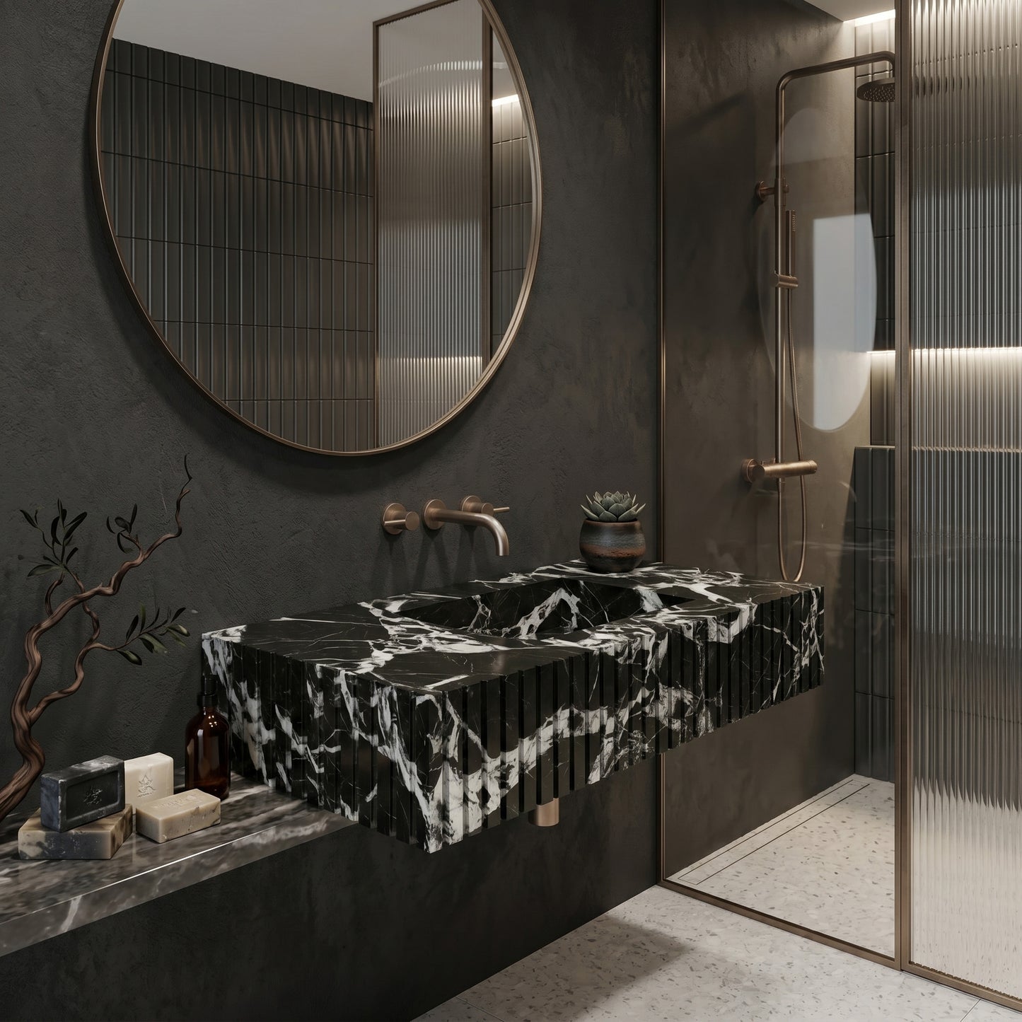 Moody luxury bathroom interior featuring a fluted Grand Antique marble single washbasin, a large round bronze-framed mirror, textured charcoal plaster walls, and a reeded glass shower screen.