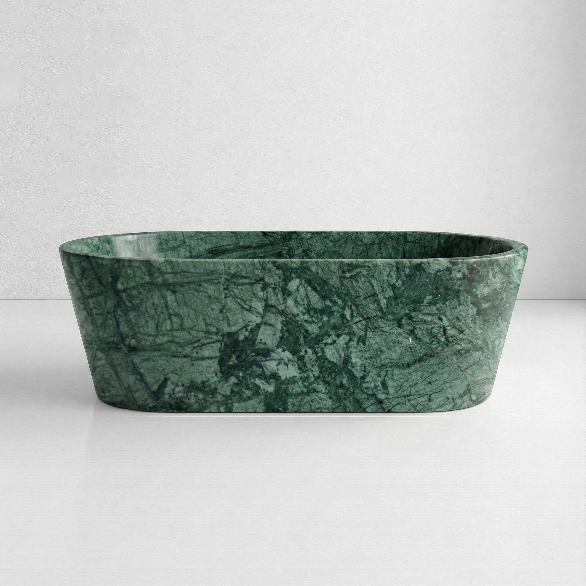 Front profile of a luxury Verde Guatemala marble bathtub featuring a polished finish and rich forest green hues with natural mineral streaks.