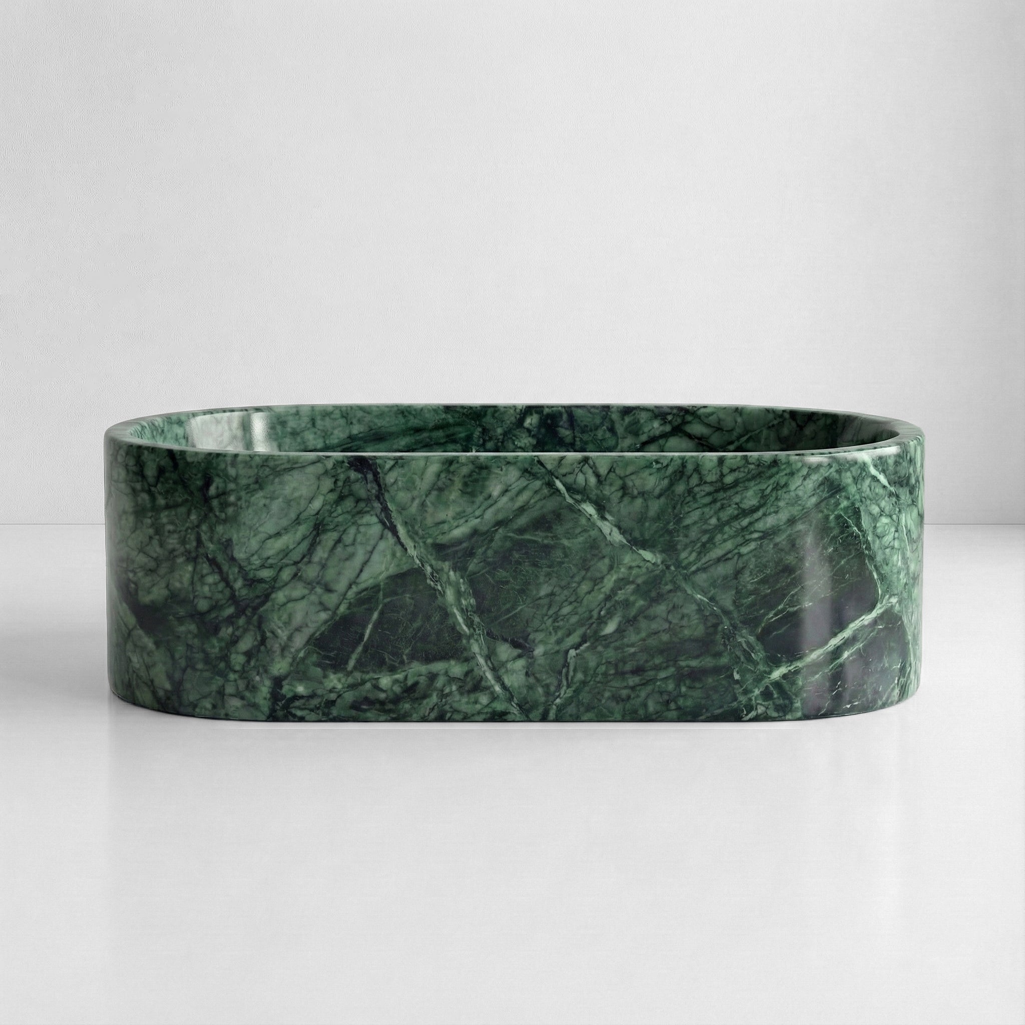 Front view of a freestanding Green Guatemala marble tub with a polished finish and dramatic forest green mineral patterns.