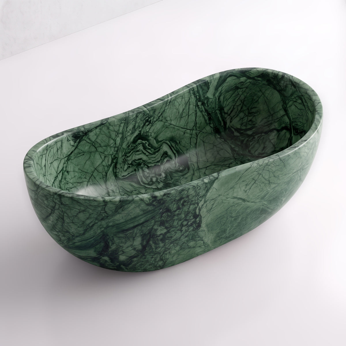 Elevated three-quarter perspective view of the Green Guatemala marble wave soaking tub, highlighting the asymmetrical undulating rim, seamless solid-carved interior, and deep forest-green mineral movement.