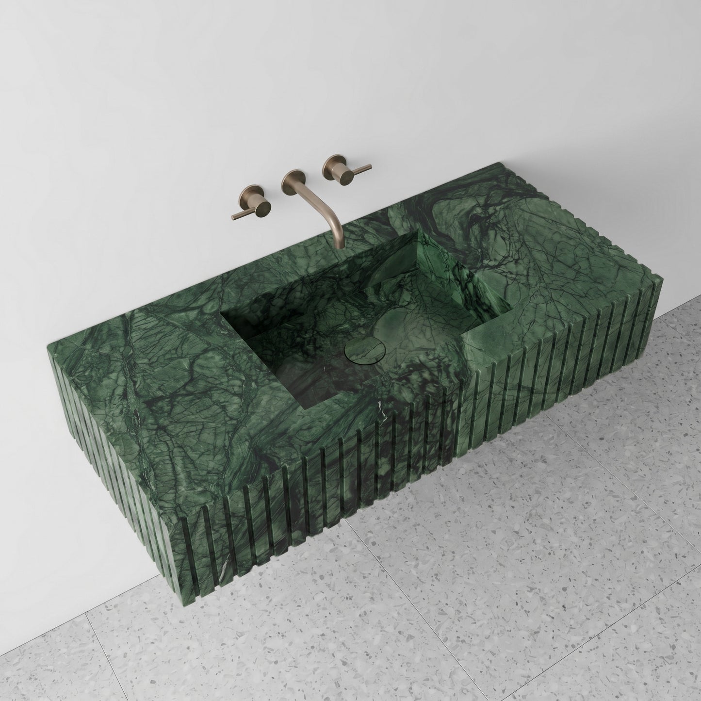 High-angle perspective view of a floating Verde Guatemala green marble single vanity, highlighting the deep forest green tones, branching black veins, integrated square basin, and light terrazzo floor tiles.