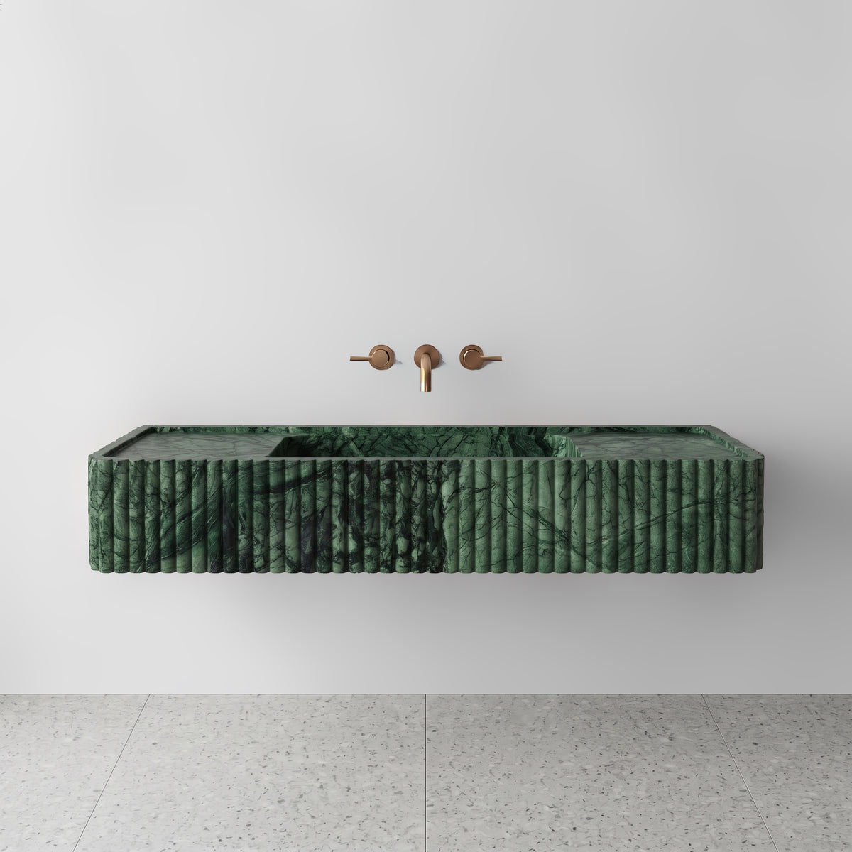 Front view of the Green Guatemala marble fluted monolith sink showing rich emerald veining across the vertical convex ribbed apron and wall-mounted brushed bronze faucet.