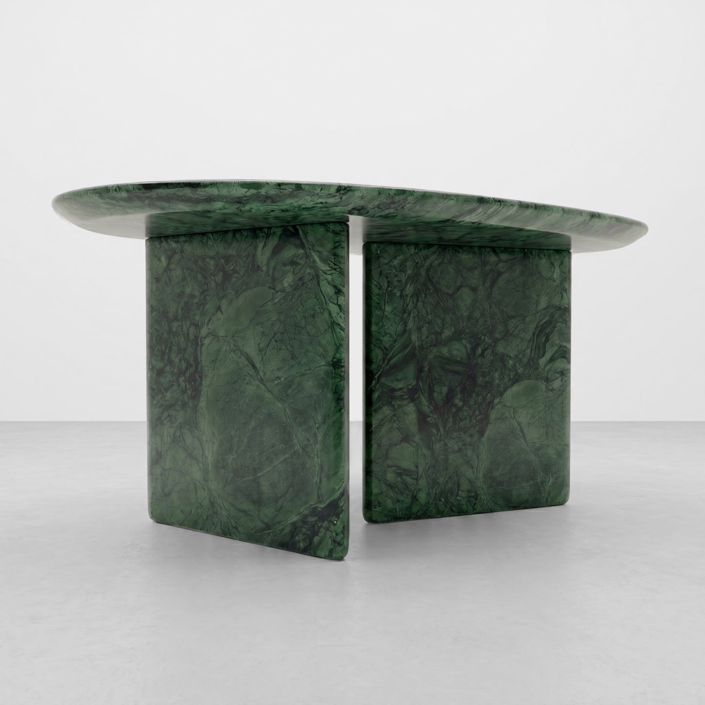 Detailed close-up view of the rich, forest green spiderweb veining and polished finish of a luxury Green Guatemala marble coffee table, highlighting the premium natural stone texture and smooth radiused edge.