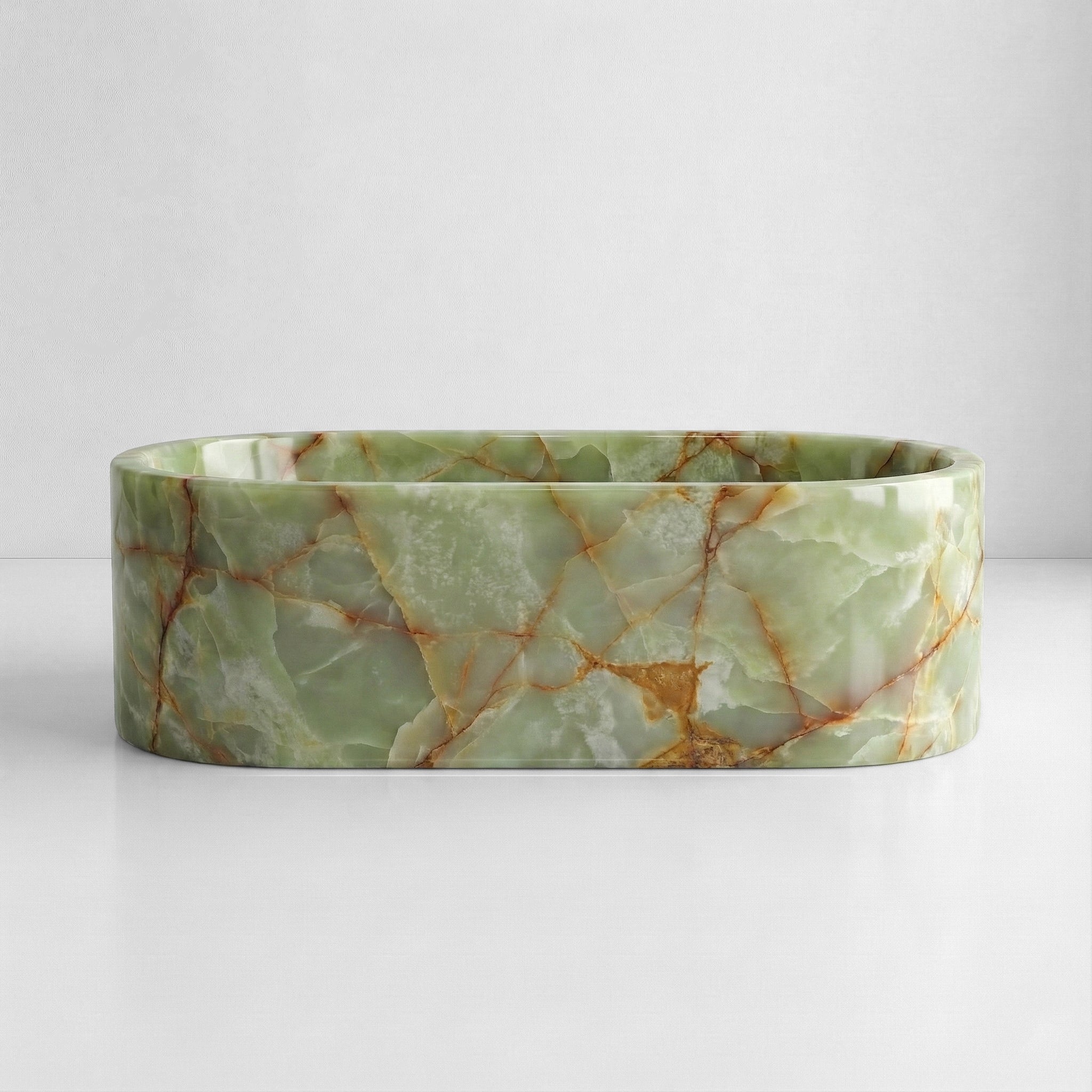 Front elevation of a luxury oval Green Onyx tub displaying a polished finish with soft green tones and natural amber mineral streaks.