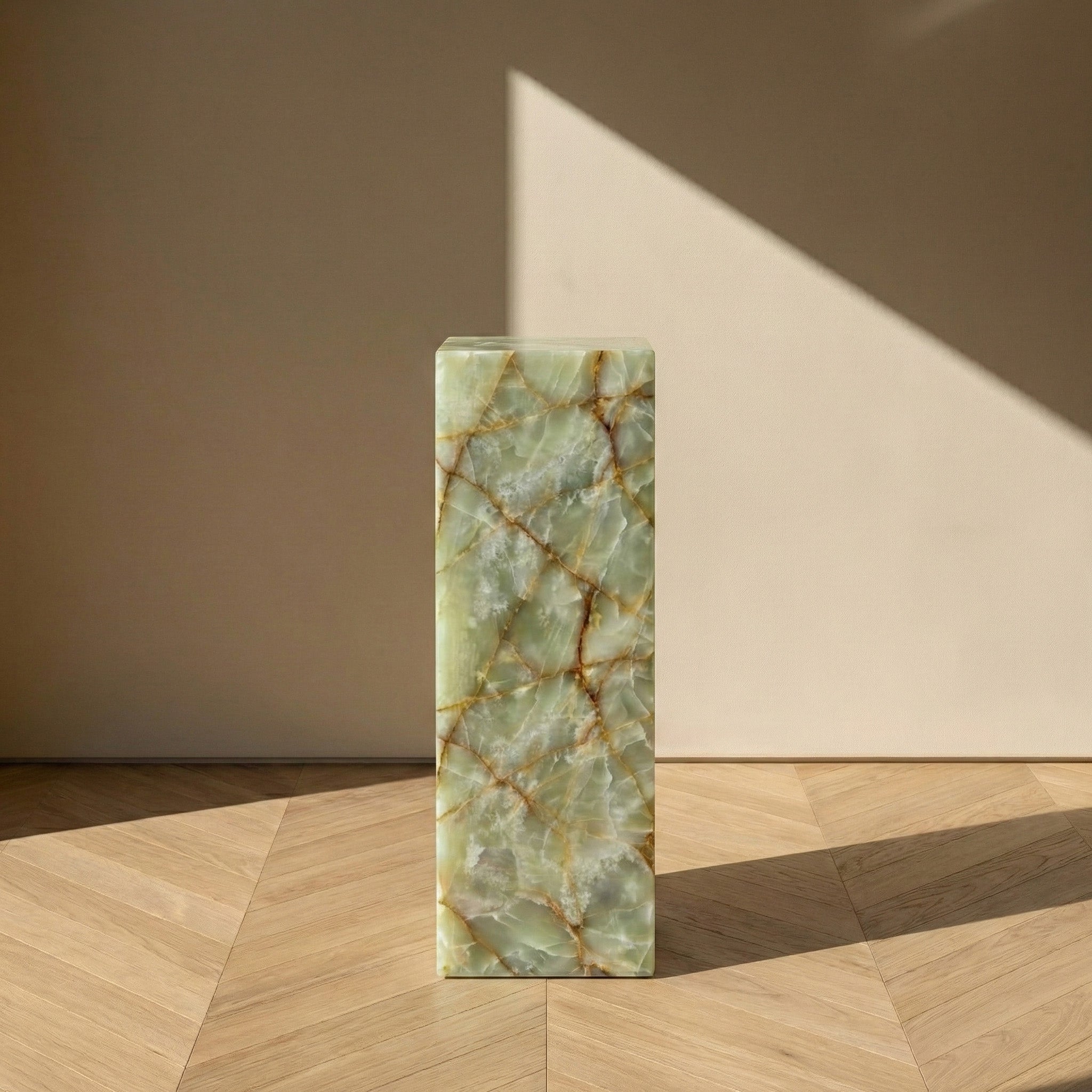 A front-facing view of a Green Onyx pedestal stand against a neutral background, emphasizing the vertical flow of the vibrant green stone and its elegant, slender proportions.