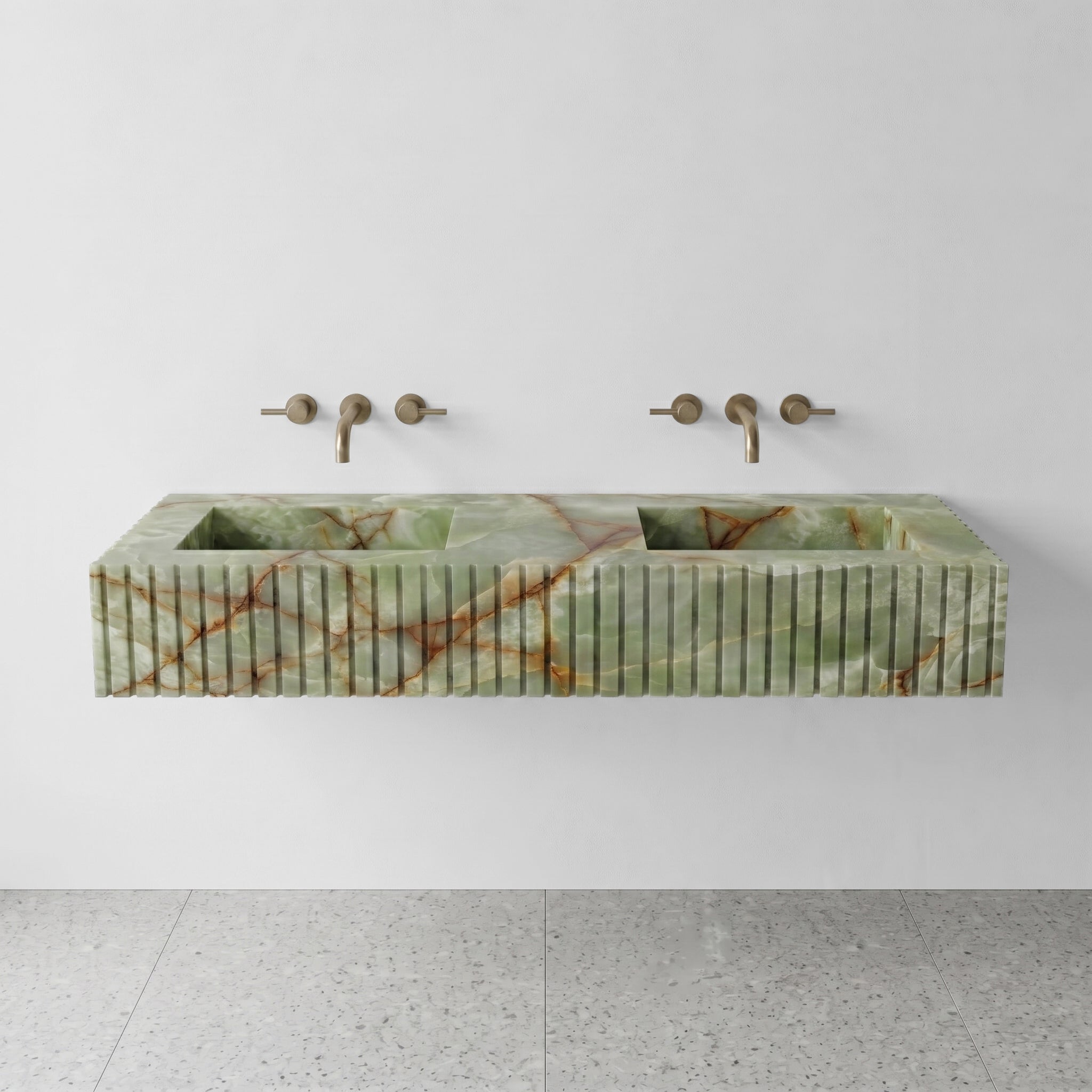 Front profile of a floating Green Onyx gemstone double sink featuring a custom fluted apron and translucent jade green stone with rust veining.
