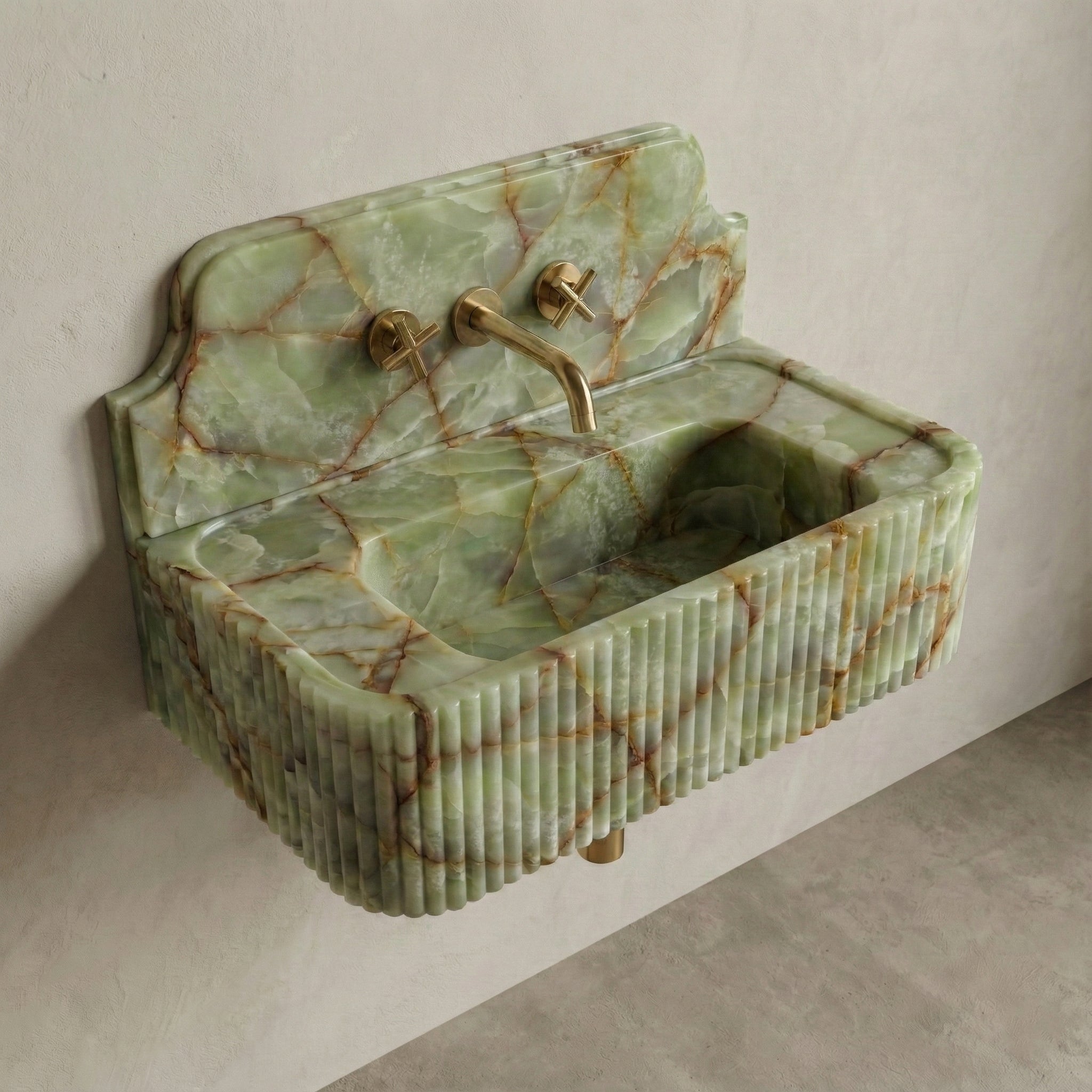 High-angle side view of a vintage-inspired Green Onyx sink, showcasing the curved stone backsplash, fluted apron, and semi-translucent jade surface.