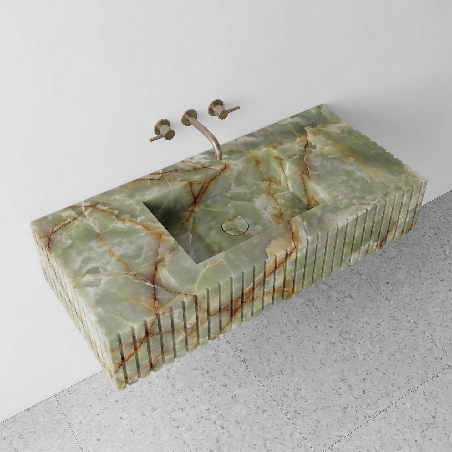 High-angle perspective view of a floating Green Onyx single vanity, highlighting the deep rust and amber veining, an integrated square basin with a matching onyx drain cover, and light grey terrazzo flooring.