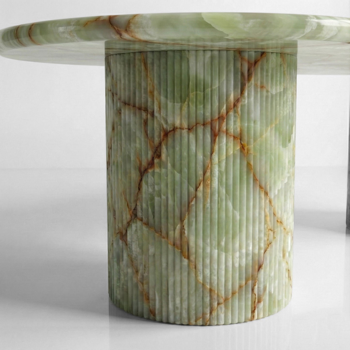 Close-up detail of a fluted column table base crafted from Green Onyx, highlighting the vertical ribbed texture and semi-translucent jade green stone.