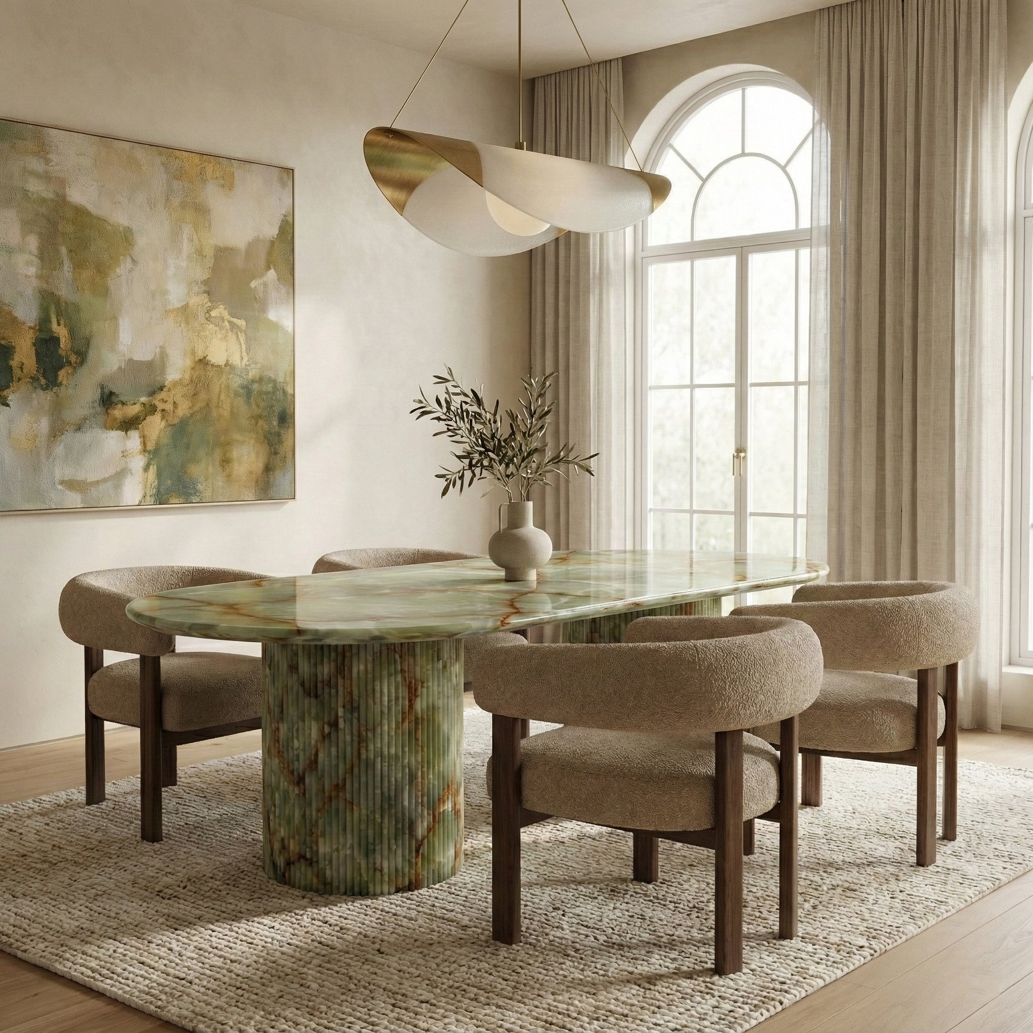 Organic luxury dining room featuring a statement Green Onyx oval table, paired with textured boucle chairs, a sculptural pendant light, and large arched windows.