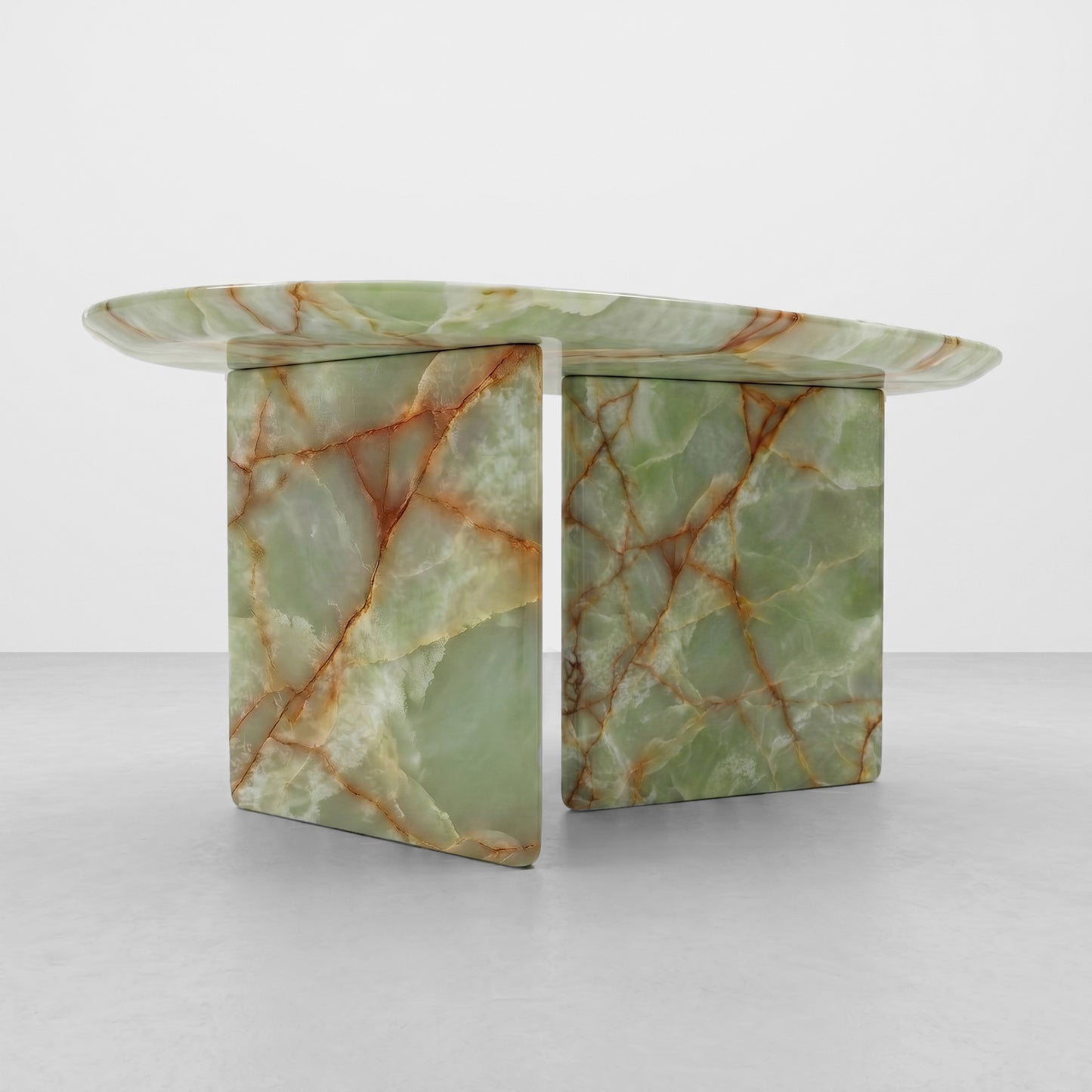 Close-up detail of the translucent green onyx stone on a bespoke coffee table, highlighting the natural rust-colored veining and high-end stone engineering on the radiused edge.