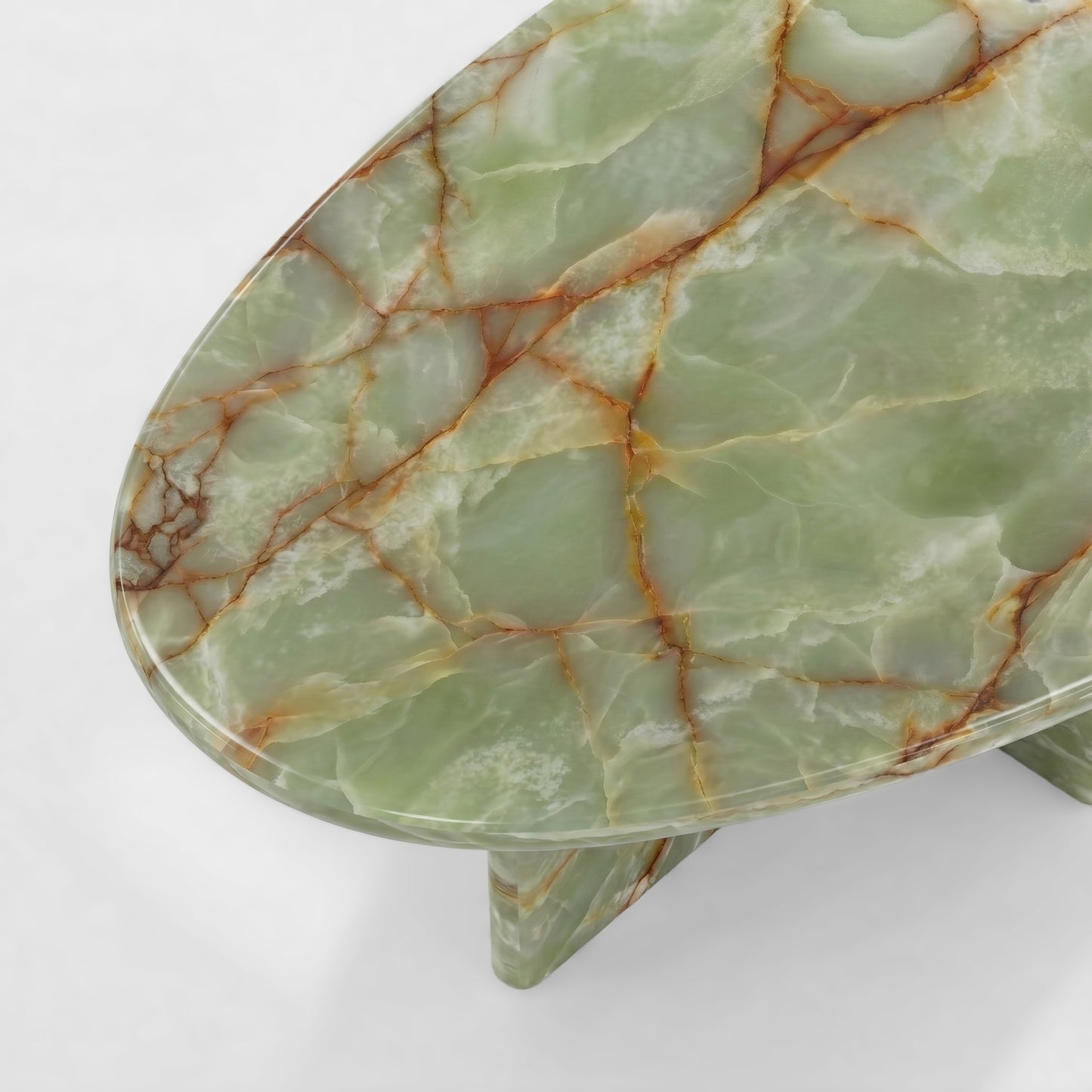 Side profile of a luxury green onyx coffee table featuring a sculptural two-leg base and a thick pebble-shaped top against a minimalist white background.