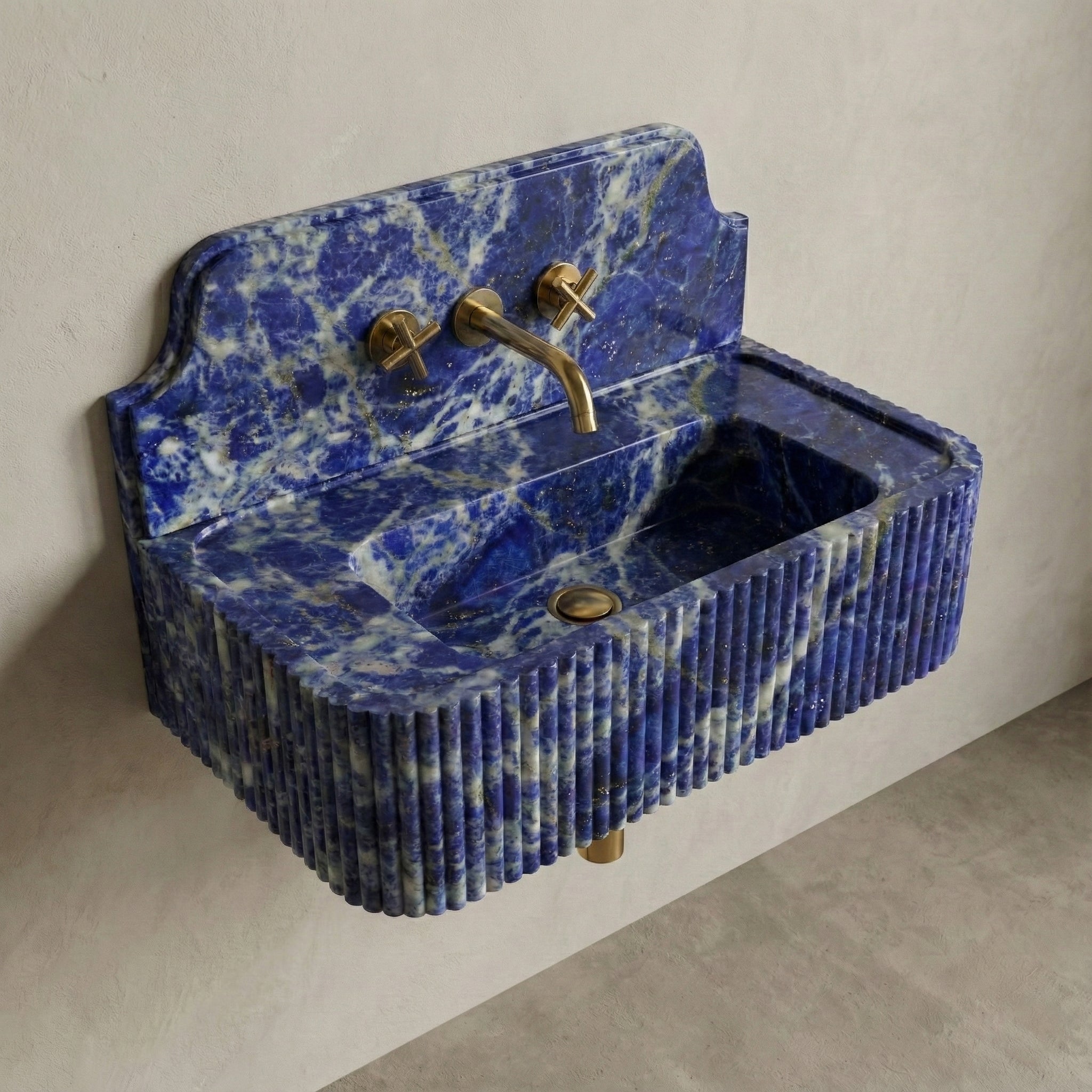 High-angle side view of a vintage-inspired Lapis Lazuli sink, showcasing the curved stone backsplash, fluted apron, and vibrant semi-precious blue surface.