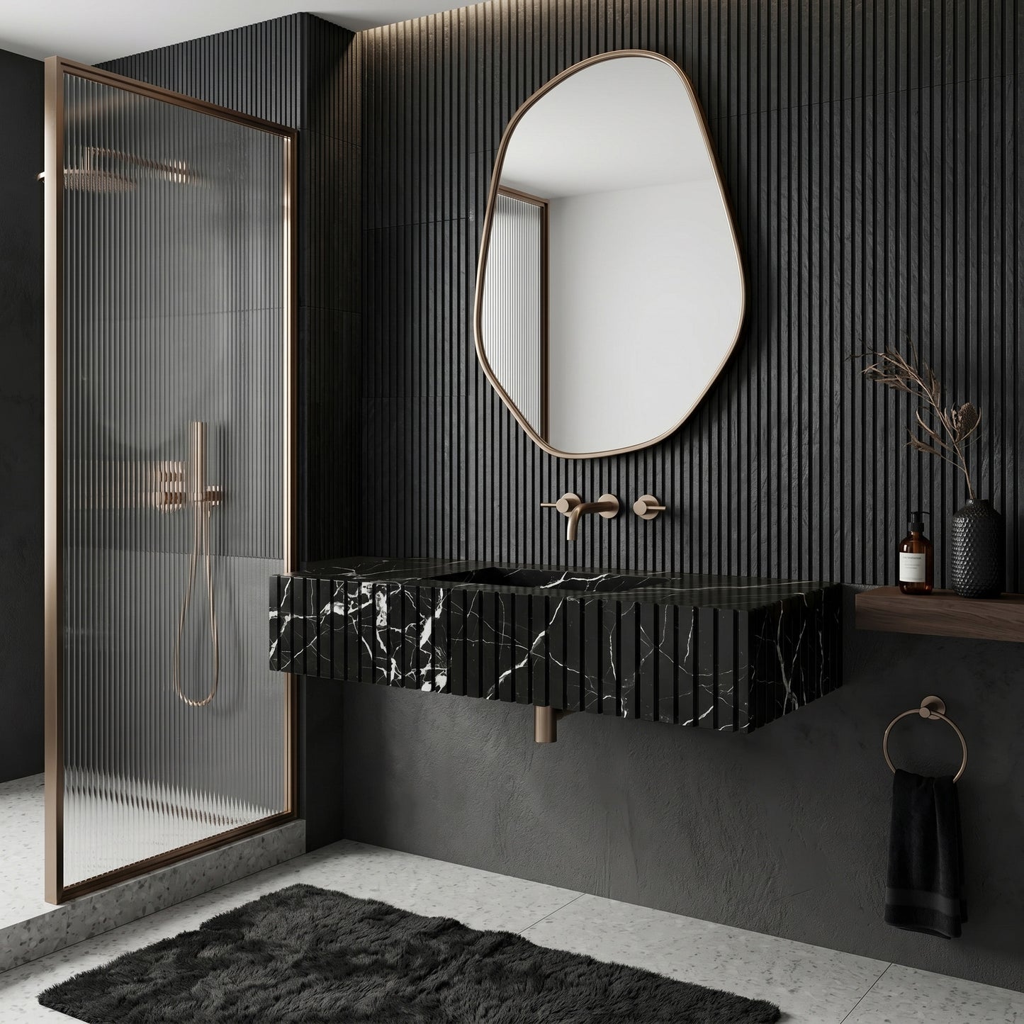 Moody monochrome bathroom interior featuring a fluted Nero Marquina black marble single sink, an asymmetrical round brass mirror, vertical black slat wall paneling, and a reeded glass shower screen.