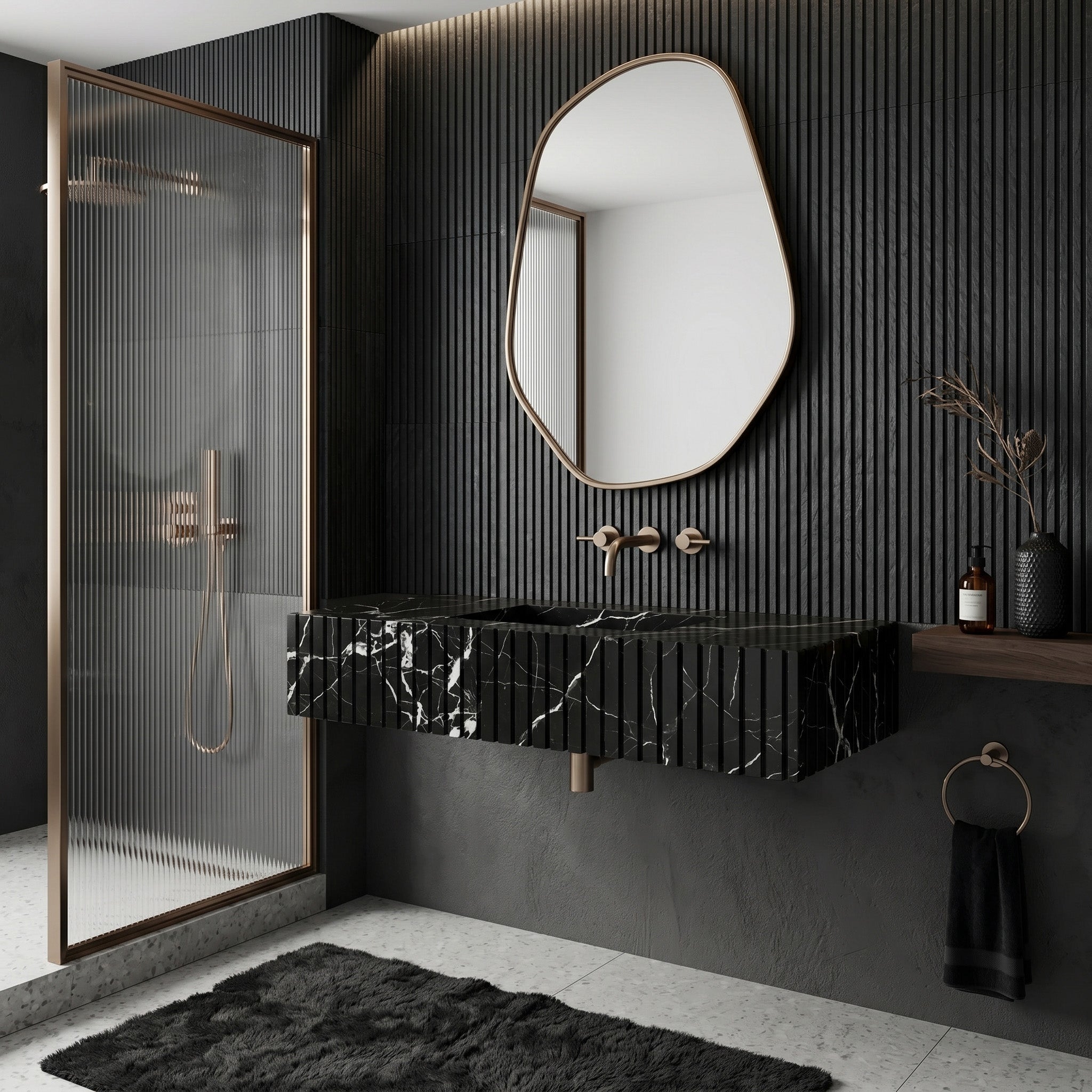 Moody monochrome bathroom interior featuring a fluted Nero Marquina black marble single sink, an asymmetrical round brass mirror, vertical black slat wall paneling, and a reeded glass shower screen.