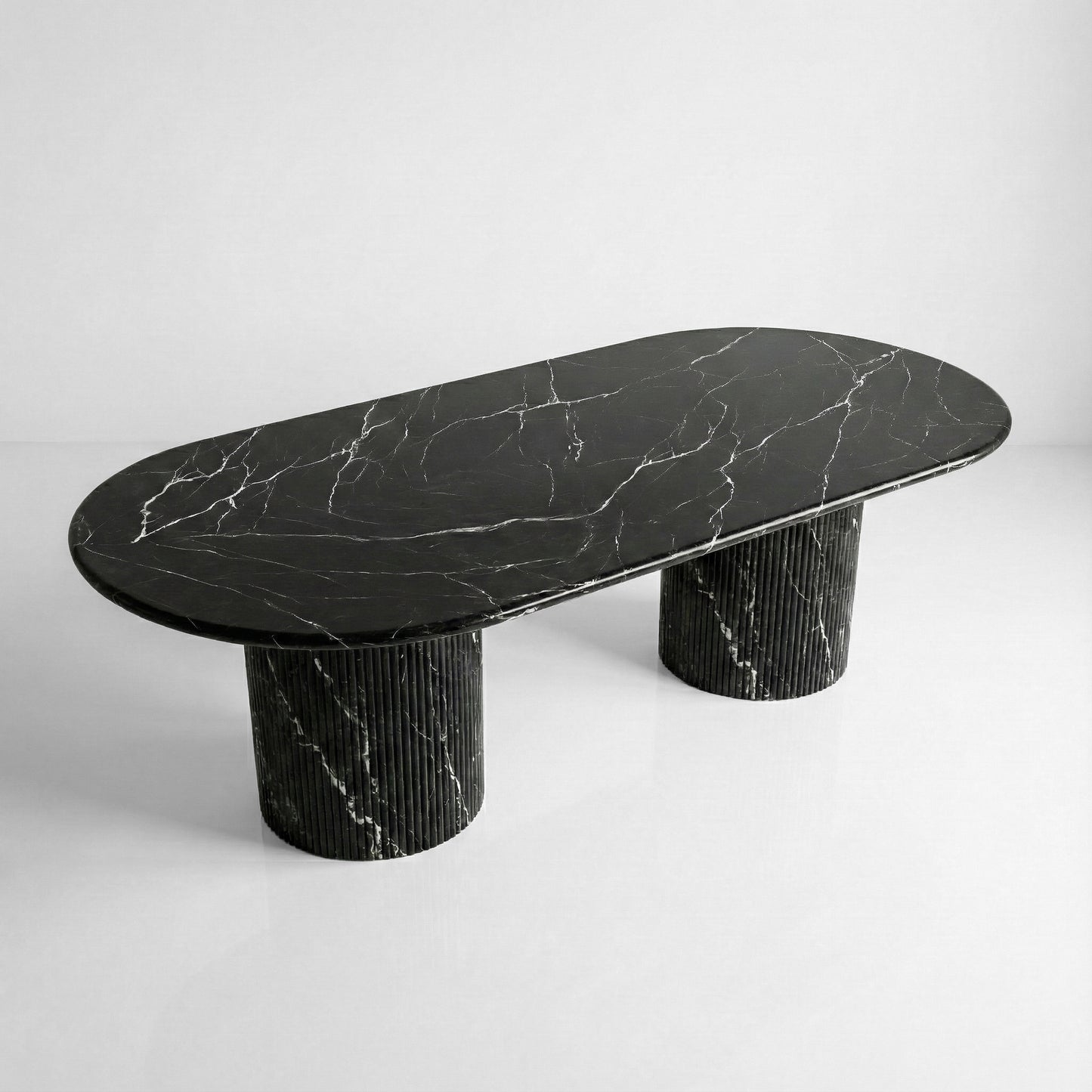 High-angle view of a large oval Nero Marquina dining table, showcasing the polished black natural stone surface with striking white lightning veining.