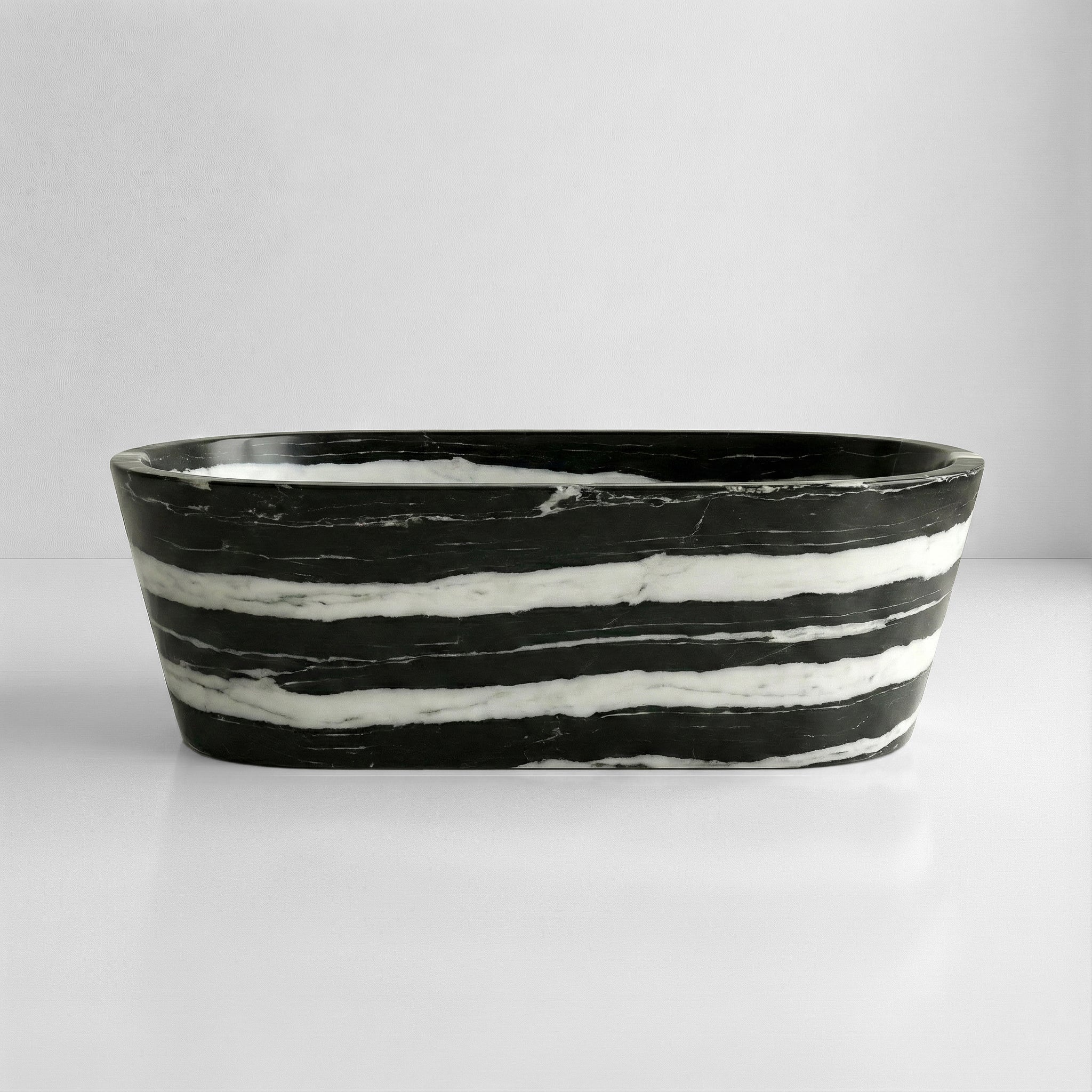 Front profile of a statement Panda White marble bathtub featuring bold, horizontal black stripes flowing across a polished white stone background.