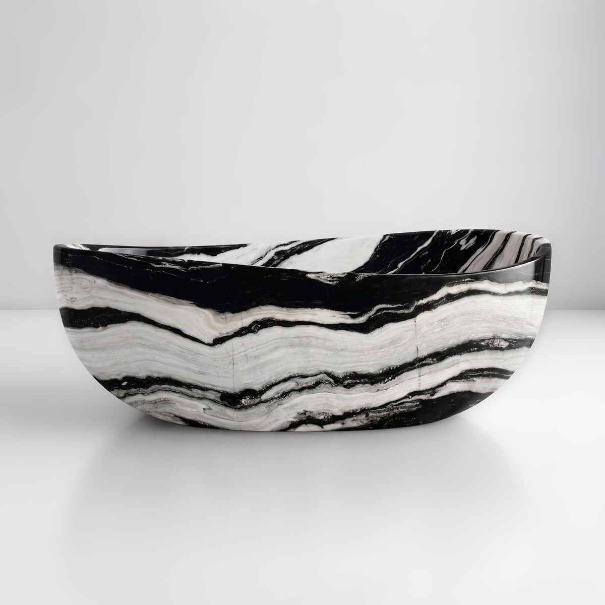 Front studio view of the freestanding Panda White marble wave bathtub, showcasing the organic dipping rim silhouette and bold, wavy horizontal black stripes flowing across a polished white stone exterior.