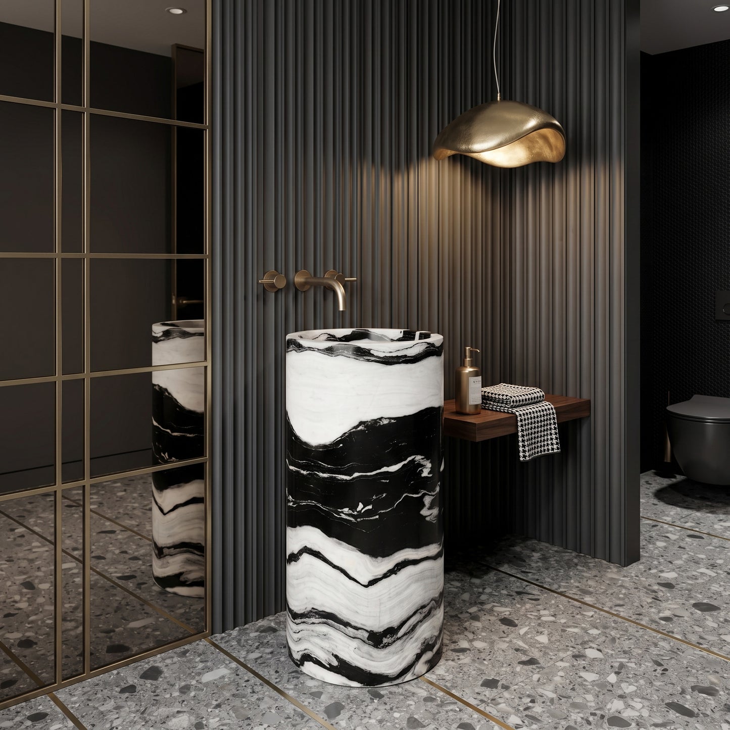 Freestanding Panda White marble round pedestal basin in a modern monochrome powder room featuring black slate flooring, brass shelves, and geometric