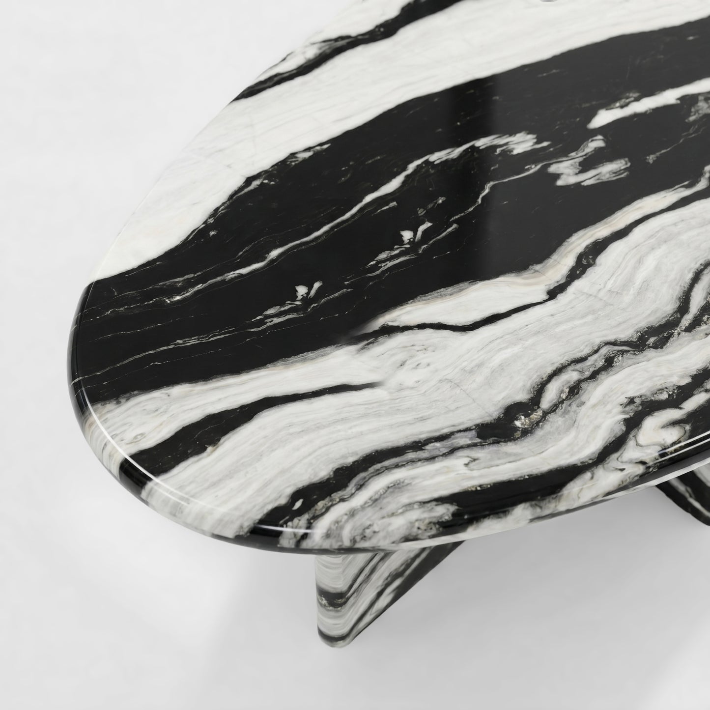 Side profile of a luxury Panda White marble coffee table featuring a sculptural two-pedestal base and a thick pebble-shaped top with dramatic black and white veining.