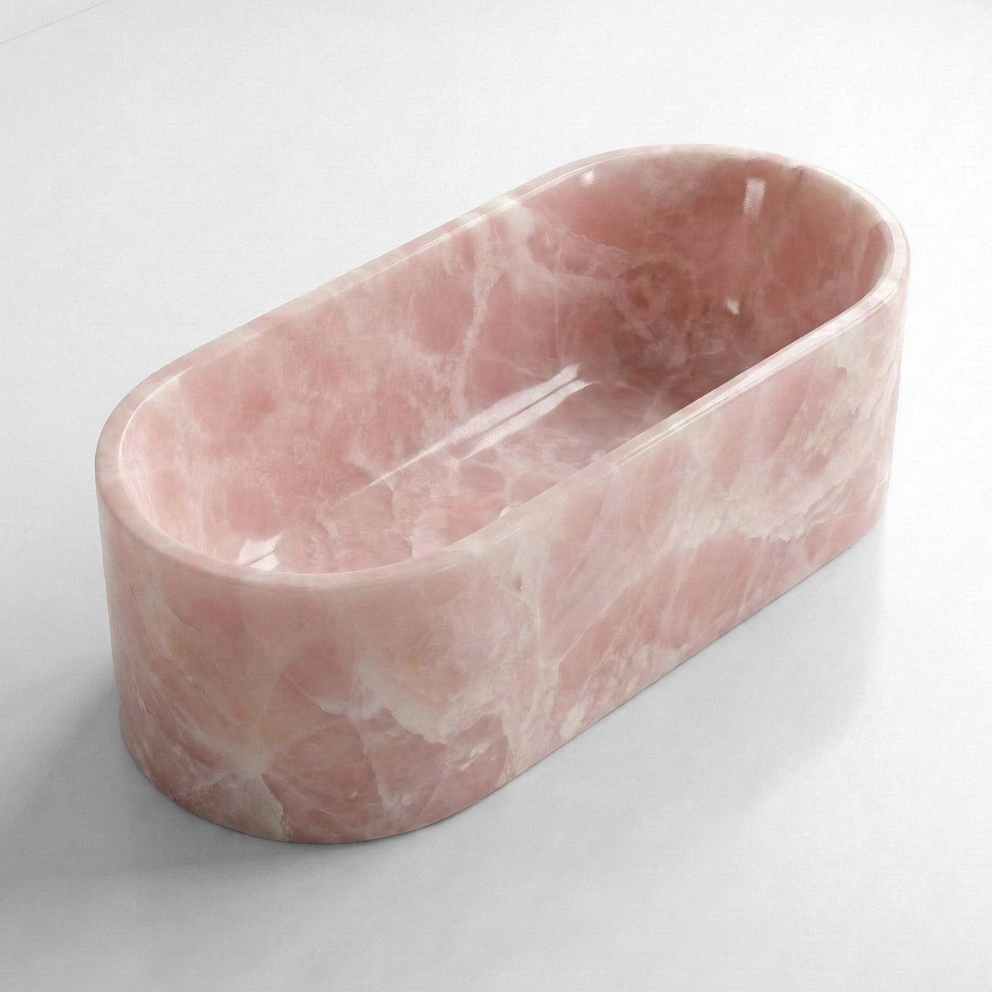 Isometric side view of a solid Pink Onyx stone tub, showcasing its smooth polished surface and ethereal semi-precious quality.