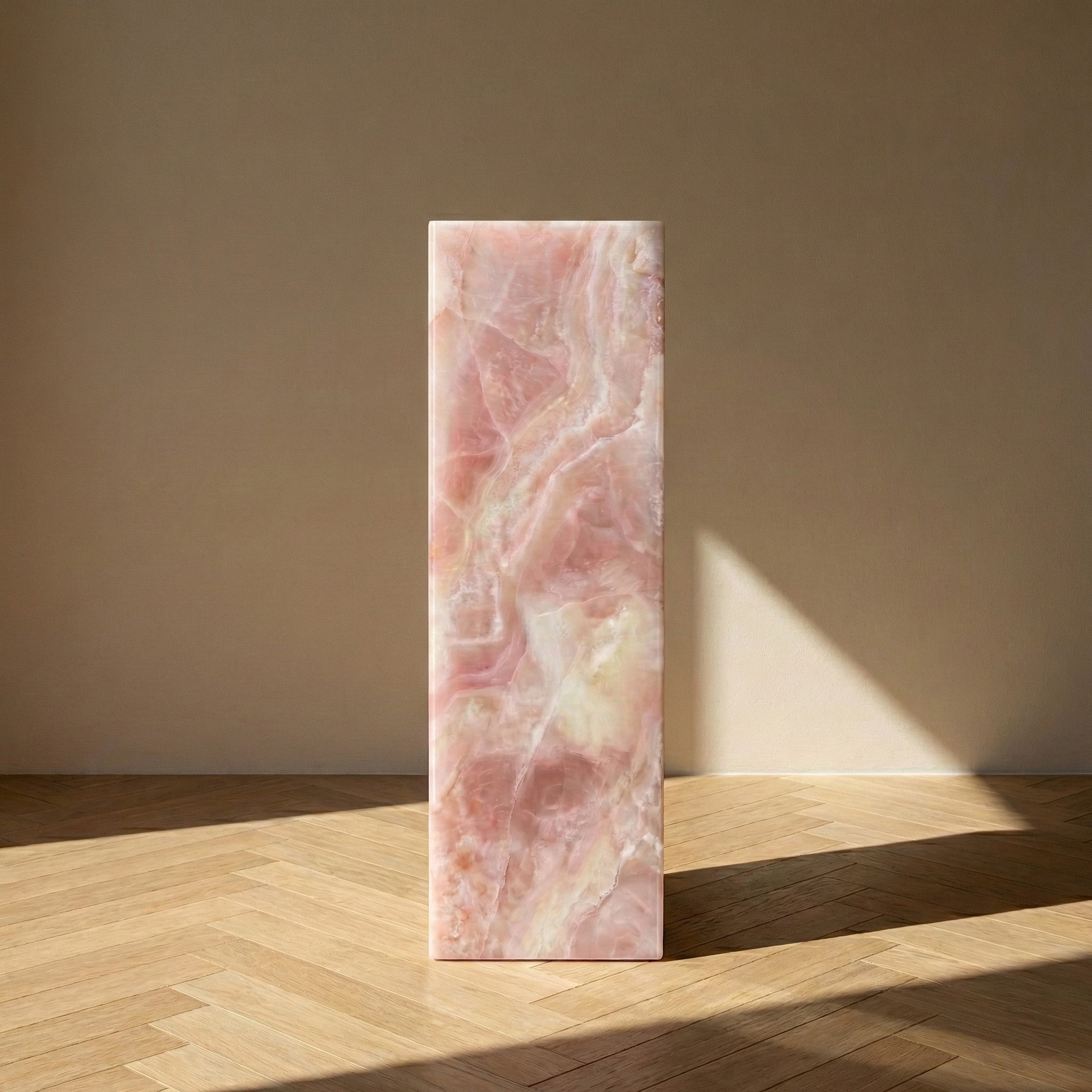 A direct front view of a Pink Onyx pedestal stand against a neutral background, displaying the vertical flow of translucent pink, white, and amber mineral formations.