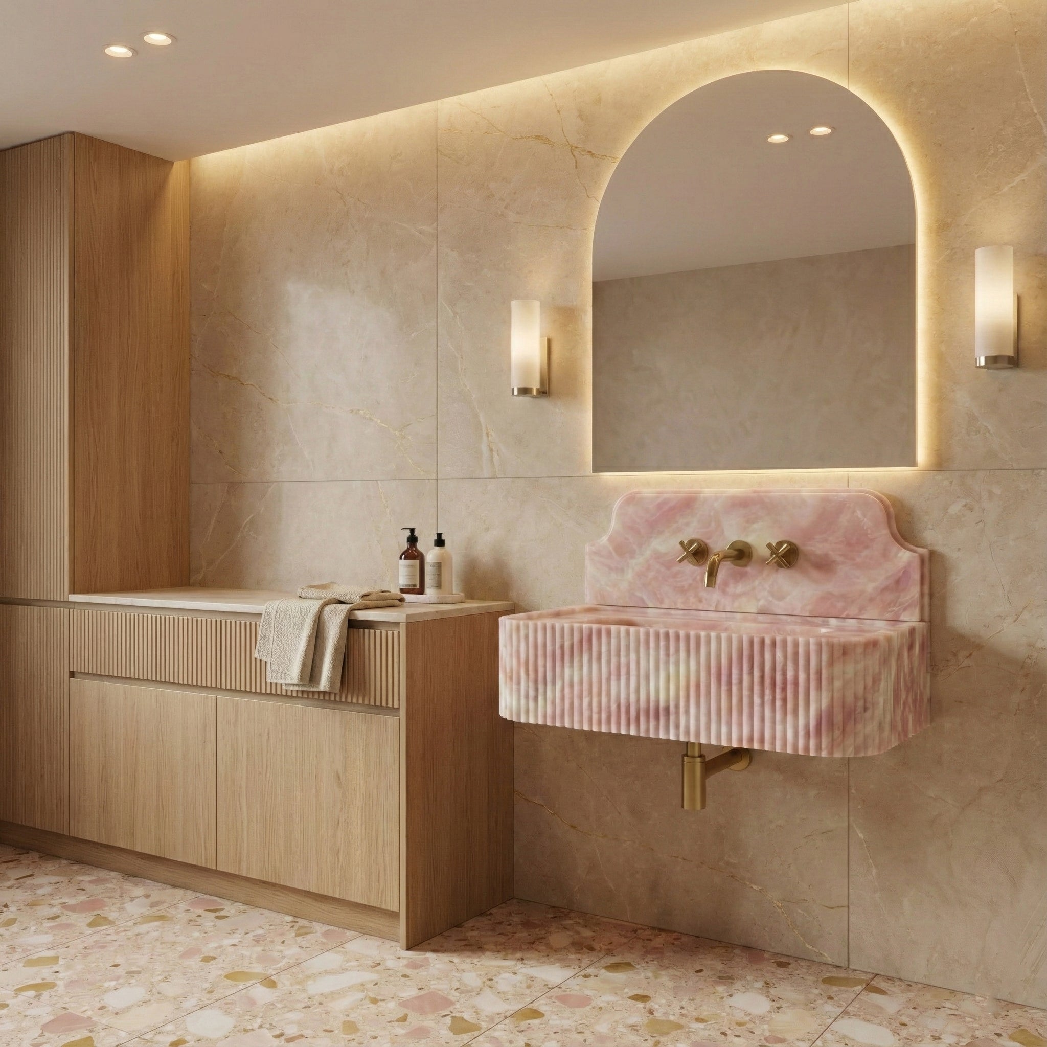 Luxury spa bathroom design centering on a Green Onyx sink with backsplash, paired with a matching stone wall, backlit mirror, and walnut vanity.