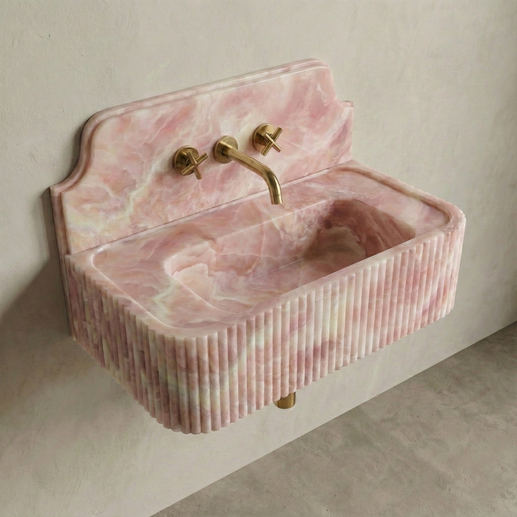 High-angle side view of a vintage-inspired Green Onyx sink, showcasing the curved stone backsplash, fluted apron, and semi-translucent jade surface.