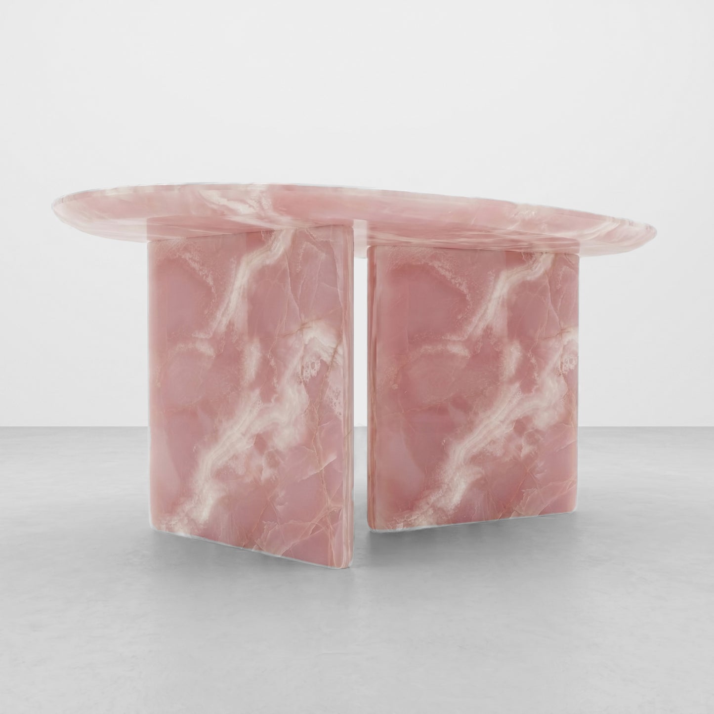 Detailed close-up of the polished surface and smooth radiused edge of a pink onyx table, highlighting the natural translucent stone and white crystalline veining.