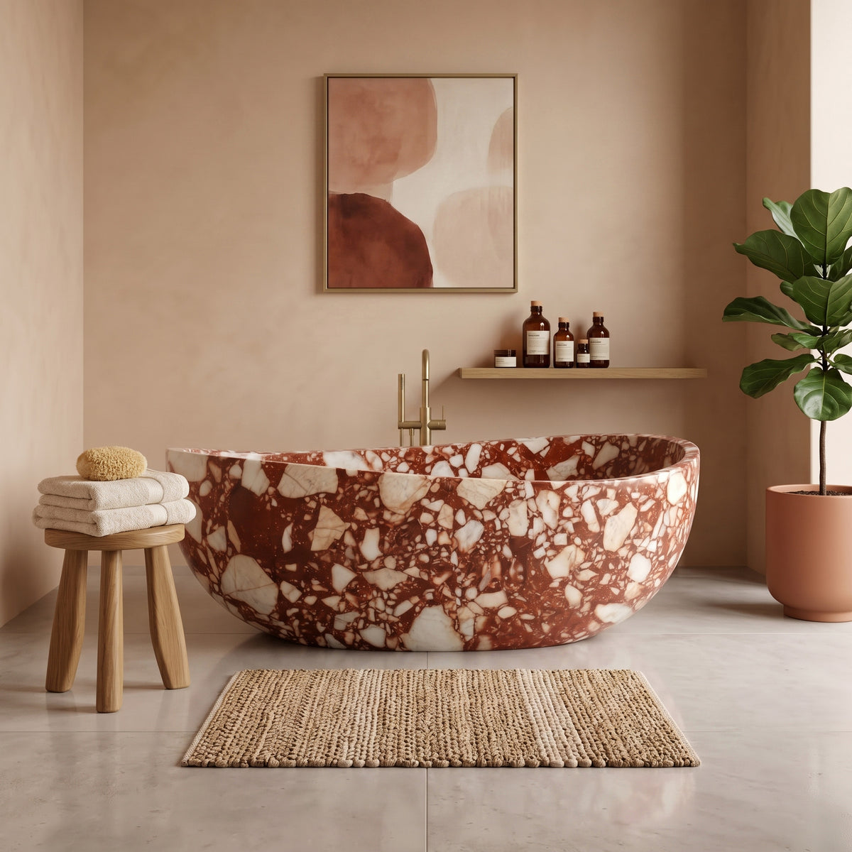 Warm minimalist bathroom interior featuring the freestanding Red Bulgari marble wave bathtub, warm peach plaster walls, a floor-mounted brushed gold tub filler, a wooden stool with folded towels, abstract wall art, and a potted plant.
