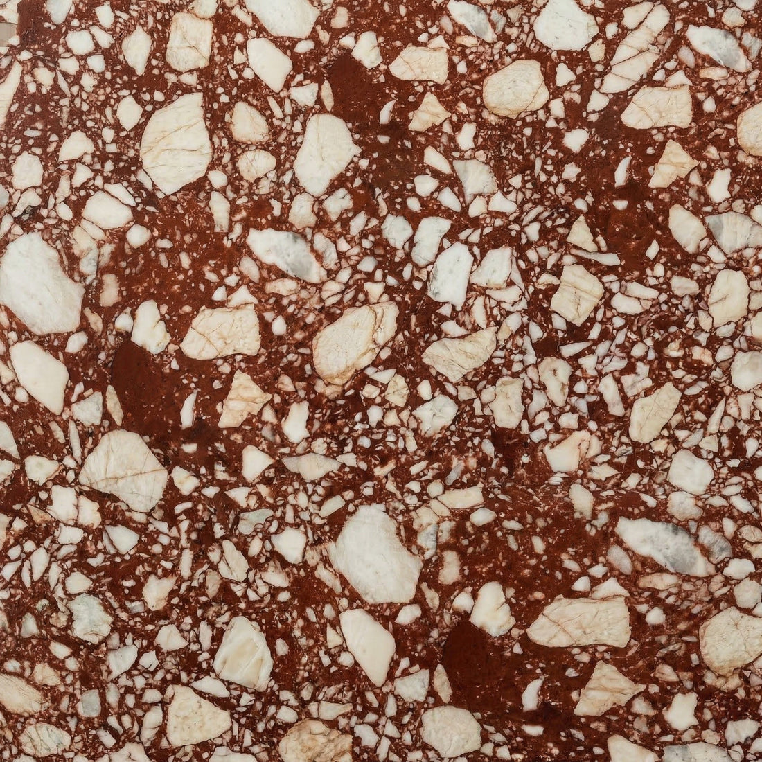 Red Bulgari brecciated marble with large white and cream fragments embedded in a deep burgundy matrix for bold flooring.