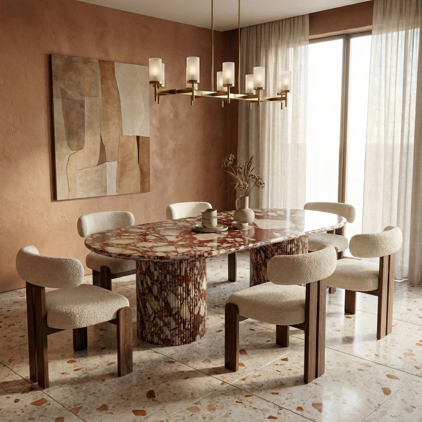 Warm luxury dining room centering on a Red Bulgari marble oval table, paired with cream boucle dining chairs, a brass linear chandelier, and terrazzo flooring.