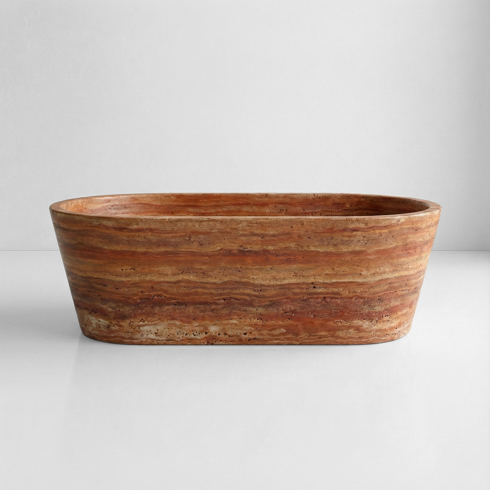 Front profile view of a statement Red Travertine bathtub displaying bold horizontal striations in deep orange and earthy red hues.