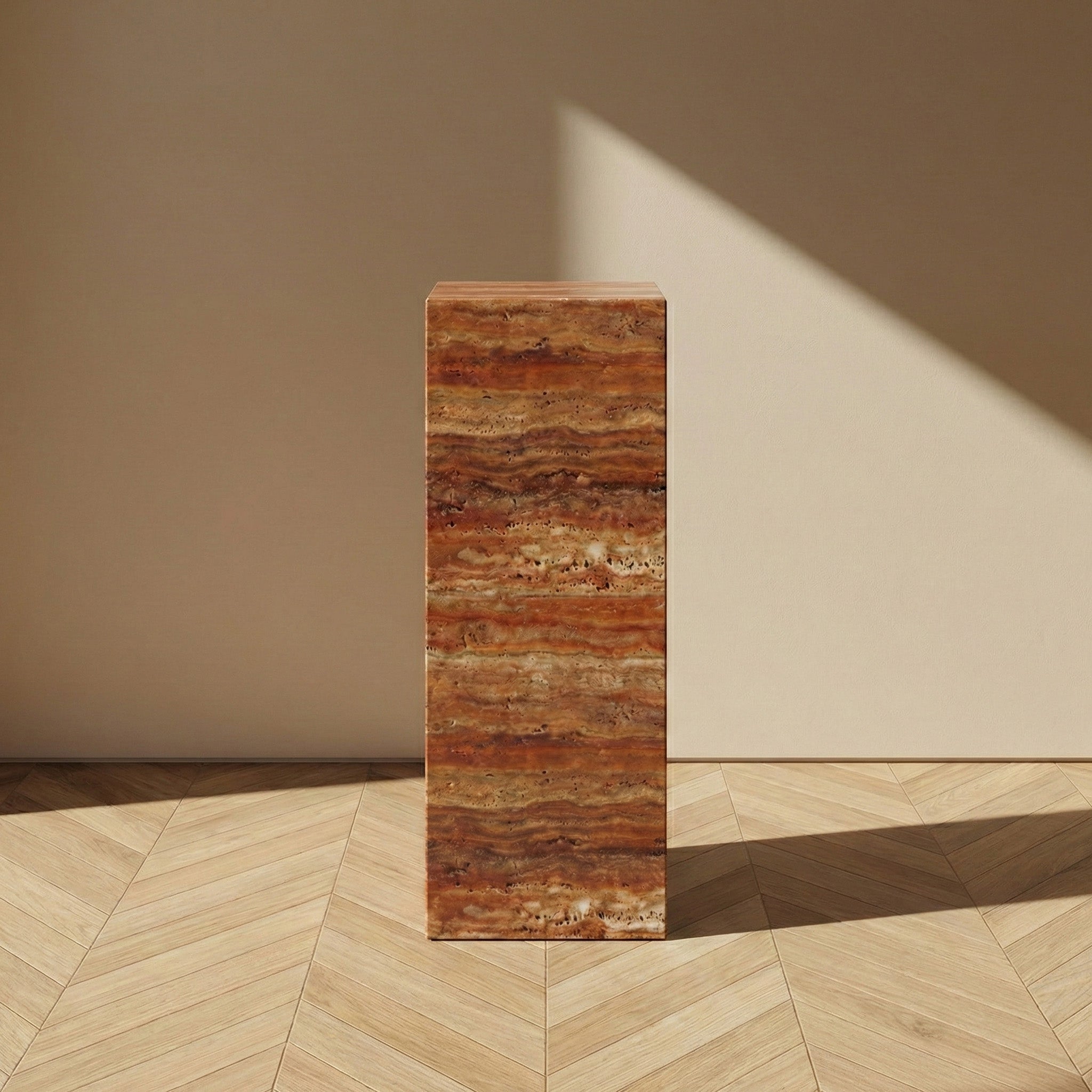 A direct, front-facing view of a Red Travertine pedestal stand against a neutral wall, emphasizing the striking "sunset" bands of crimson and ochre within the natural stone.