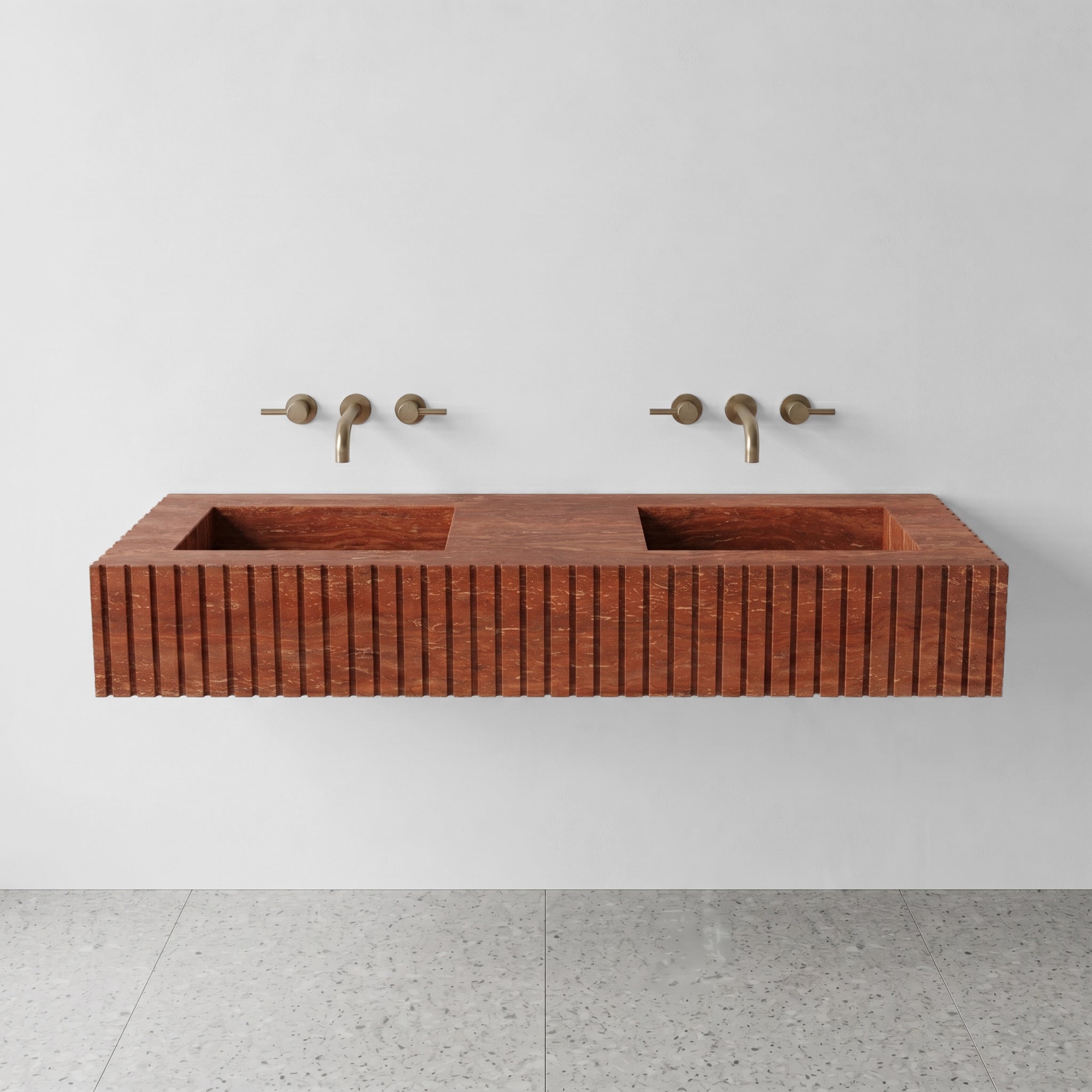 Front profile of a wall-mounted Red Travertine double vanity featuring a custom fluted stone apron and horizontal rust-colored striations.