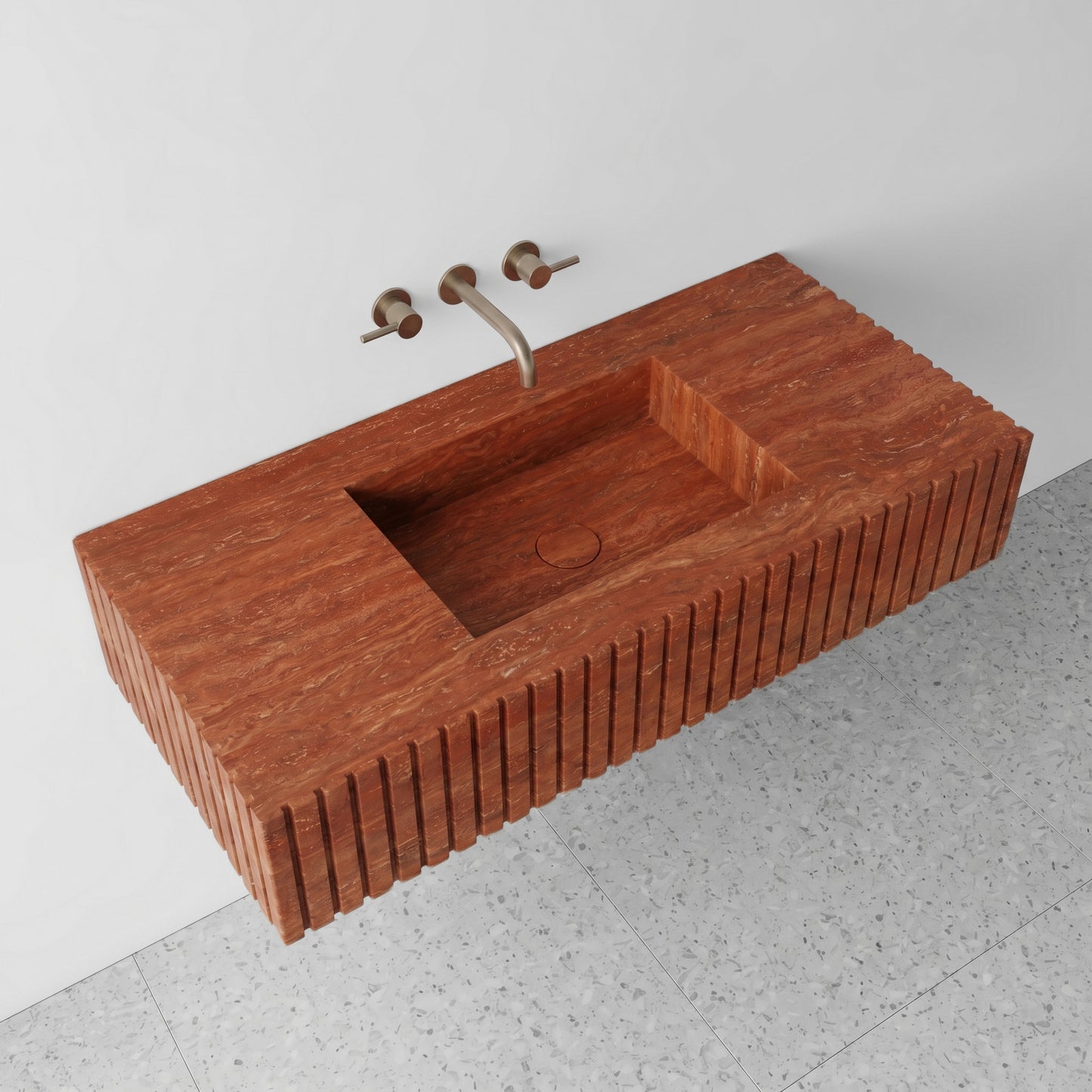 High-angle perspective view of a floating Red Travertine single washbasin, showcasing the organic horizontal grain, a matching stone integrated square sink and drain cover, and terrazzo floor tiles.