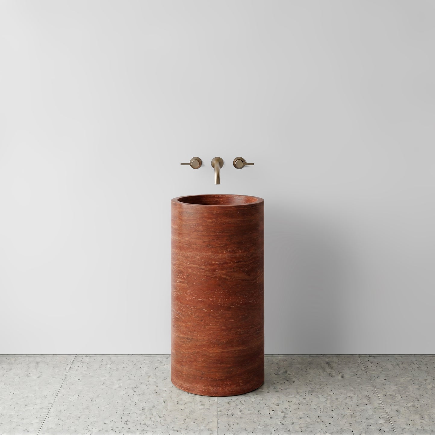 Front view of a solid Red Travertine cylinder pedestal sink showcasing rich terracotta sediment banding with wall-mounted bronze tapware.