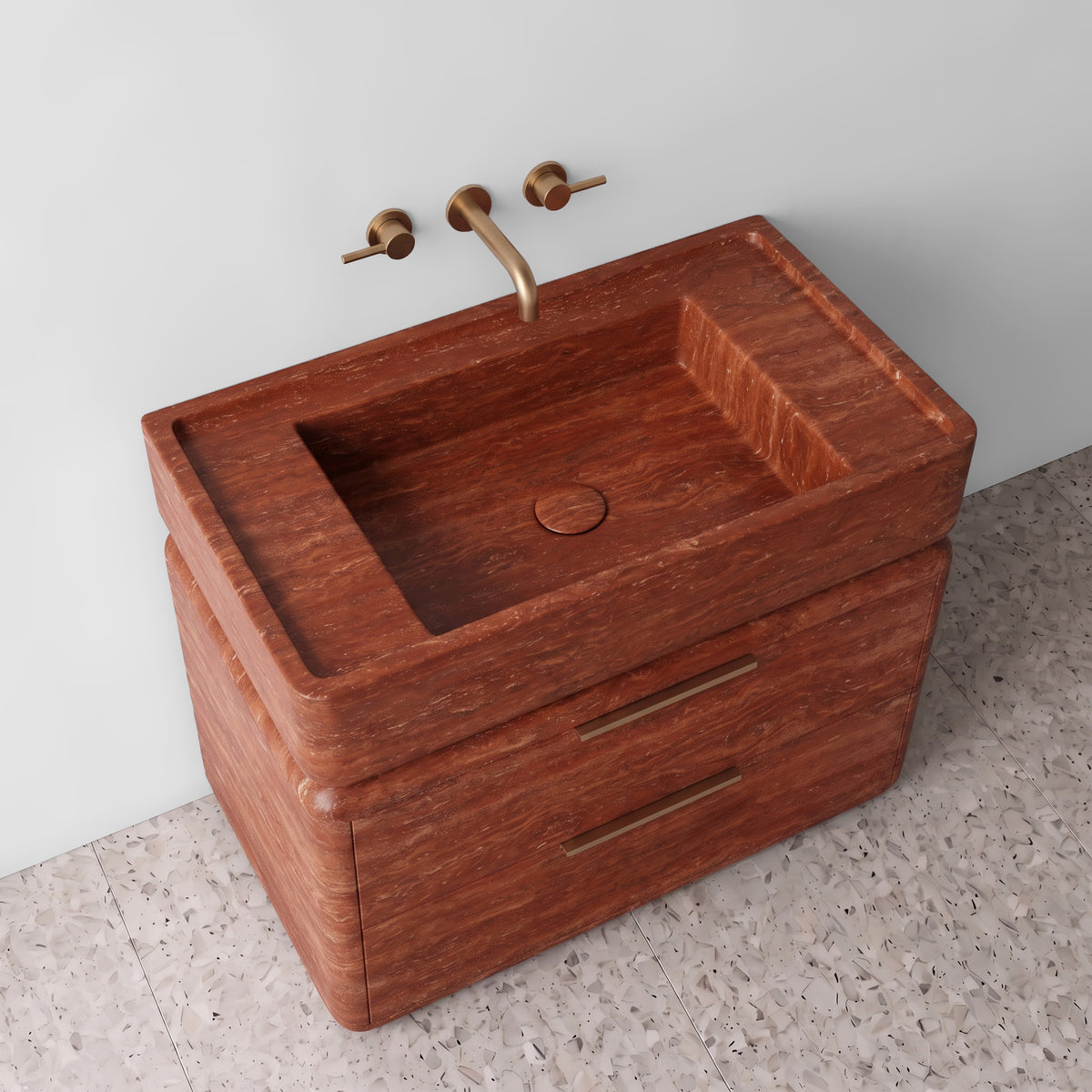 High-angle perspective view of the Red Travertine double-drawer vanity, highlighting the integrated trough sink with a matching stone drain cover, raised perimeter border, rounded drawer corners, brushed brass linear hardware, and layered terracotta-red sedimentary banding.