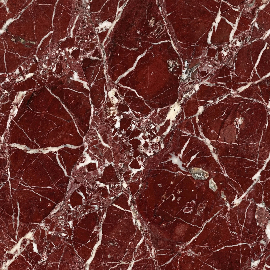 Deep red Rosso Levanto marble with prominent white and grey veining, ideal for classical fireplace surrounds and luxury bathrooms.