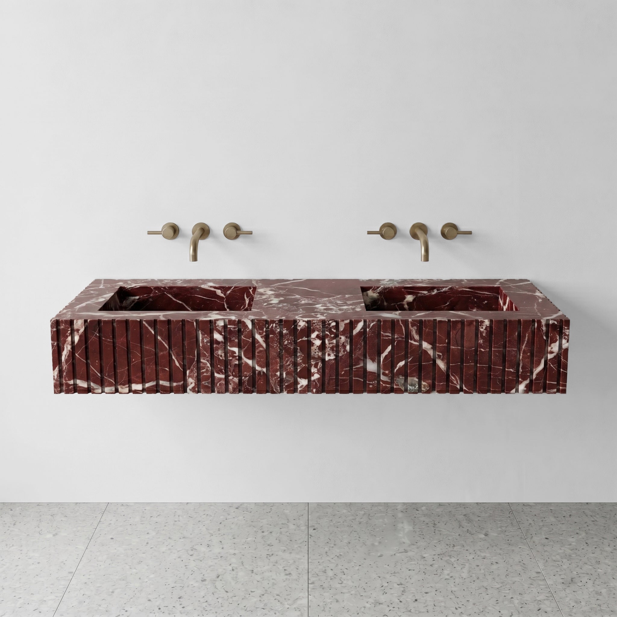 Front profile of a floating double vanity crafted from Rosso Levanto marble, displaying a custom vertical ribbed apron and striking white lightning veins.