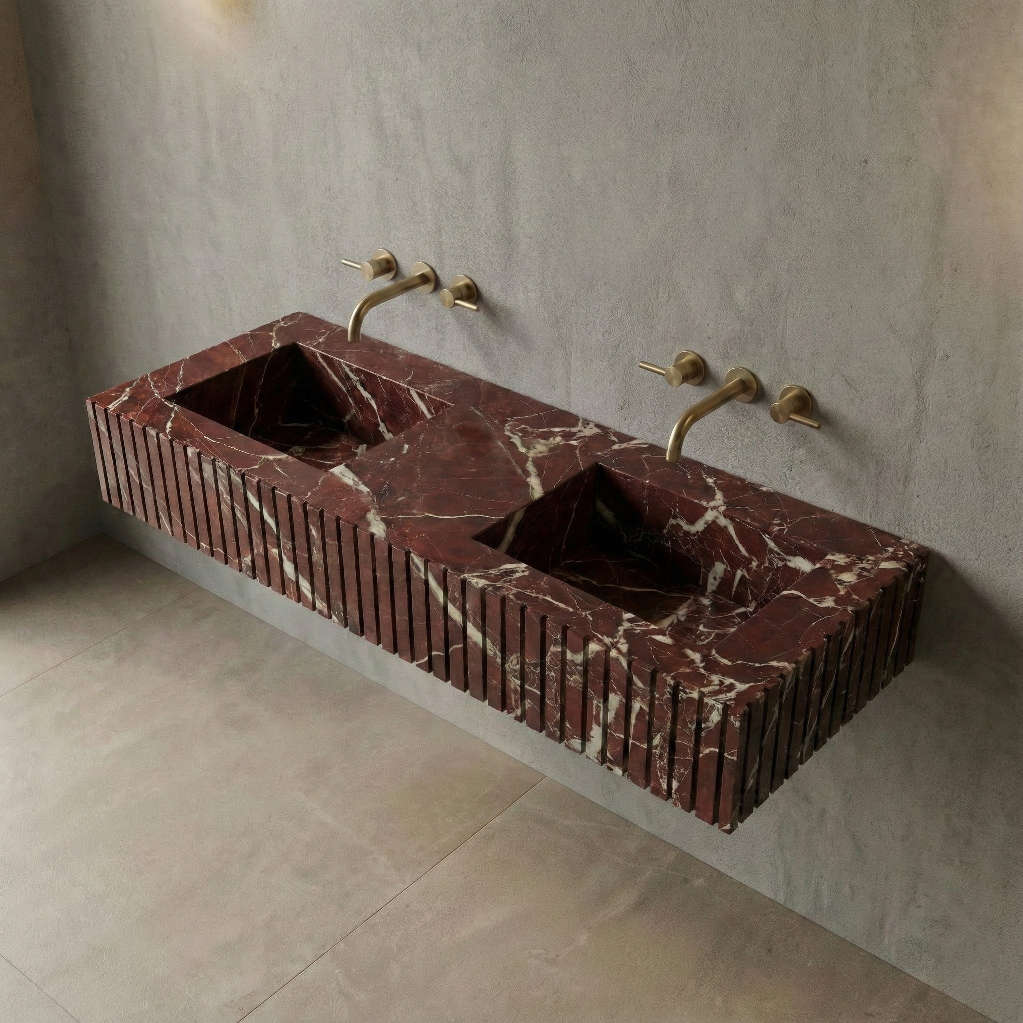 High-angle view of a wall-mounted Rosso Levanto marble sink featuring dual integrated basins and deep burgundy stone with white veining.