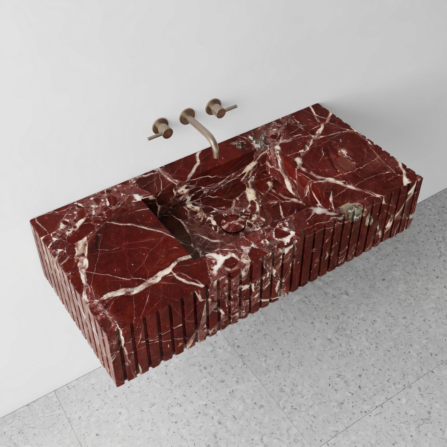 High-angle perspective view of a floating Rosso Levanto red marble single washbasin, highlighting the intense white spiderweb veining, integrated square sink with a matching stone drain cover, and grey terrazzo floor tiles.