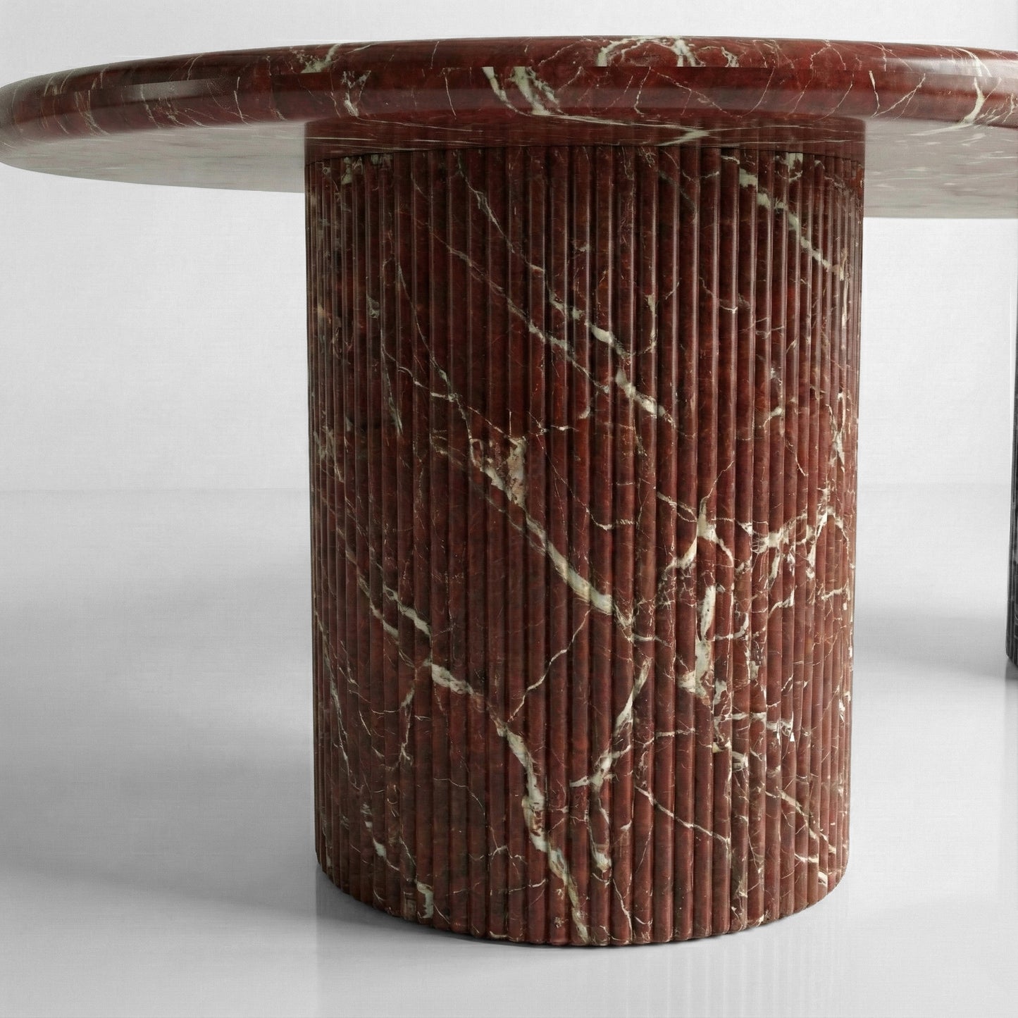 Close-up detail of a fluted column table base crafted from Rosso Levanto marble, highlighting the vertical ribbed texture and deep burgundy stone color.