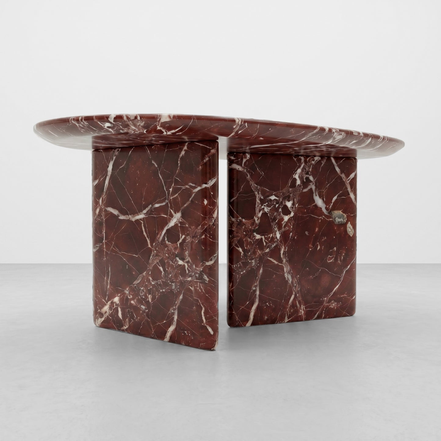 Close-up detail of the deep cherry red and white lightning veining of polished Rosso Levanto marble, highlighting the premium natural stone texture and smooth radiused edge.