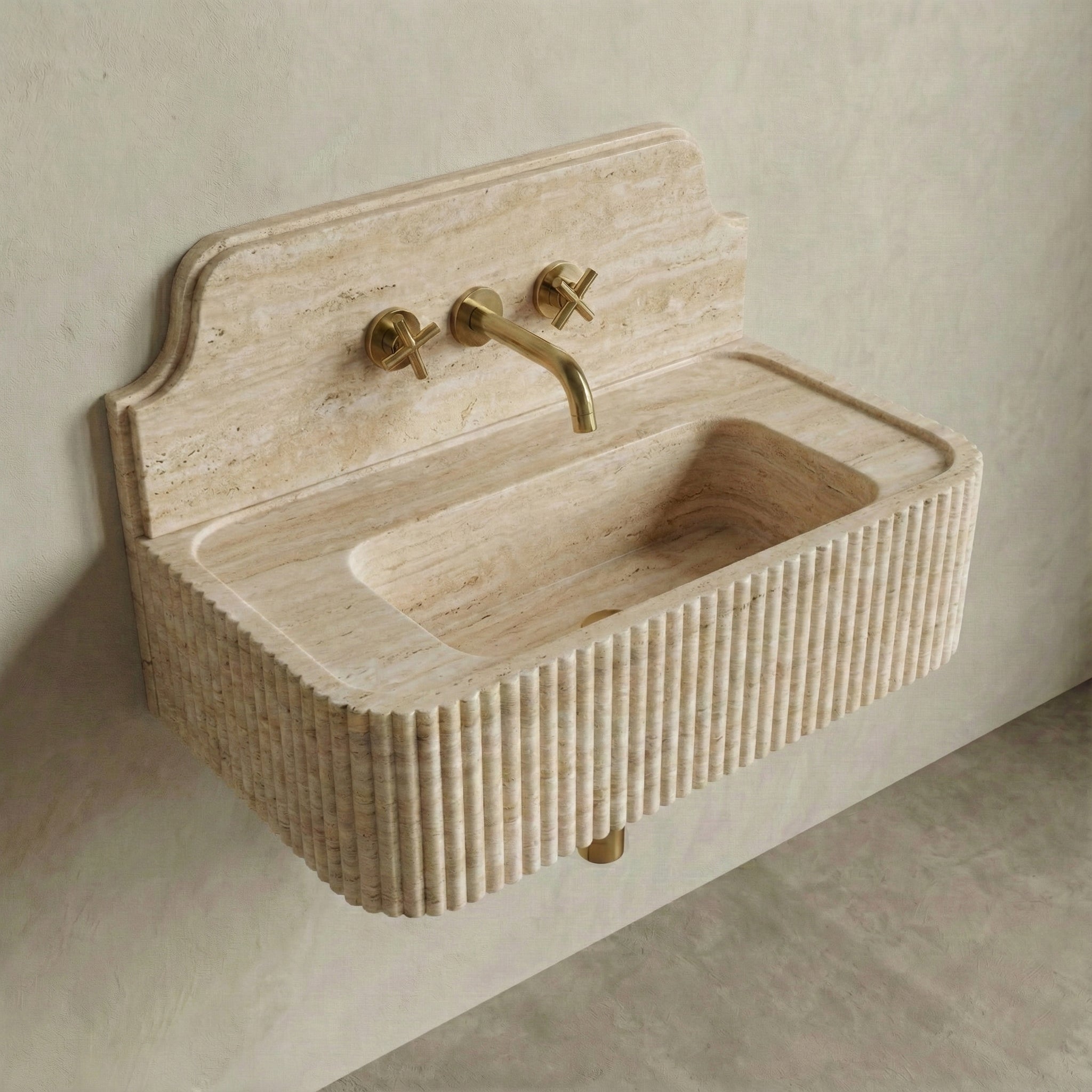 High-angle side view of a vintage-inspired Travertine Romano sink, showcasing the curved stone backsplash, fluted apron, and natural beige vein-cut texture.