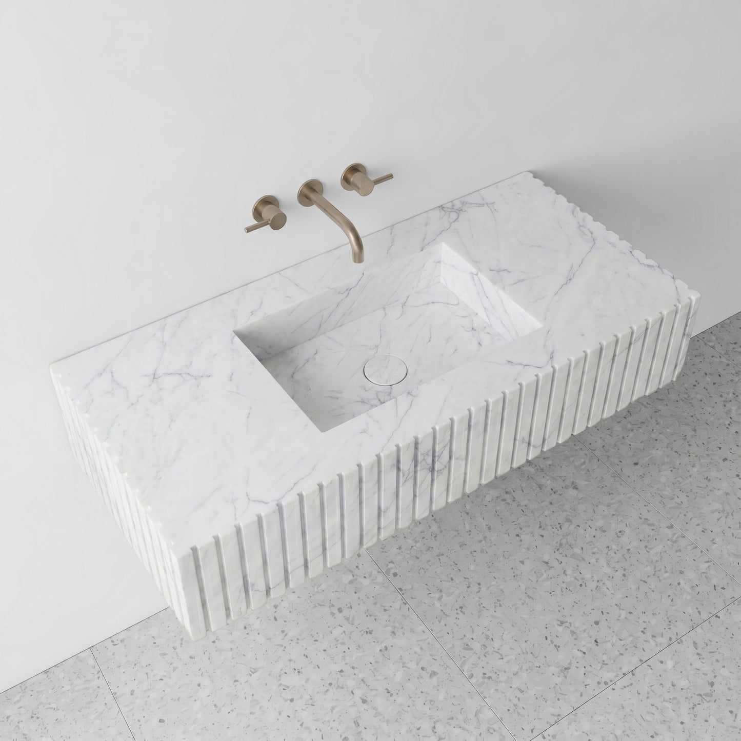 High-angle perspective view of a floating White Carrara marble single vanity, showcasing the subtle grey feather veining, an integrated square basin with a matching marble drain cover, and light terrazzo flooring.