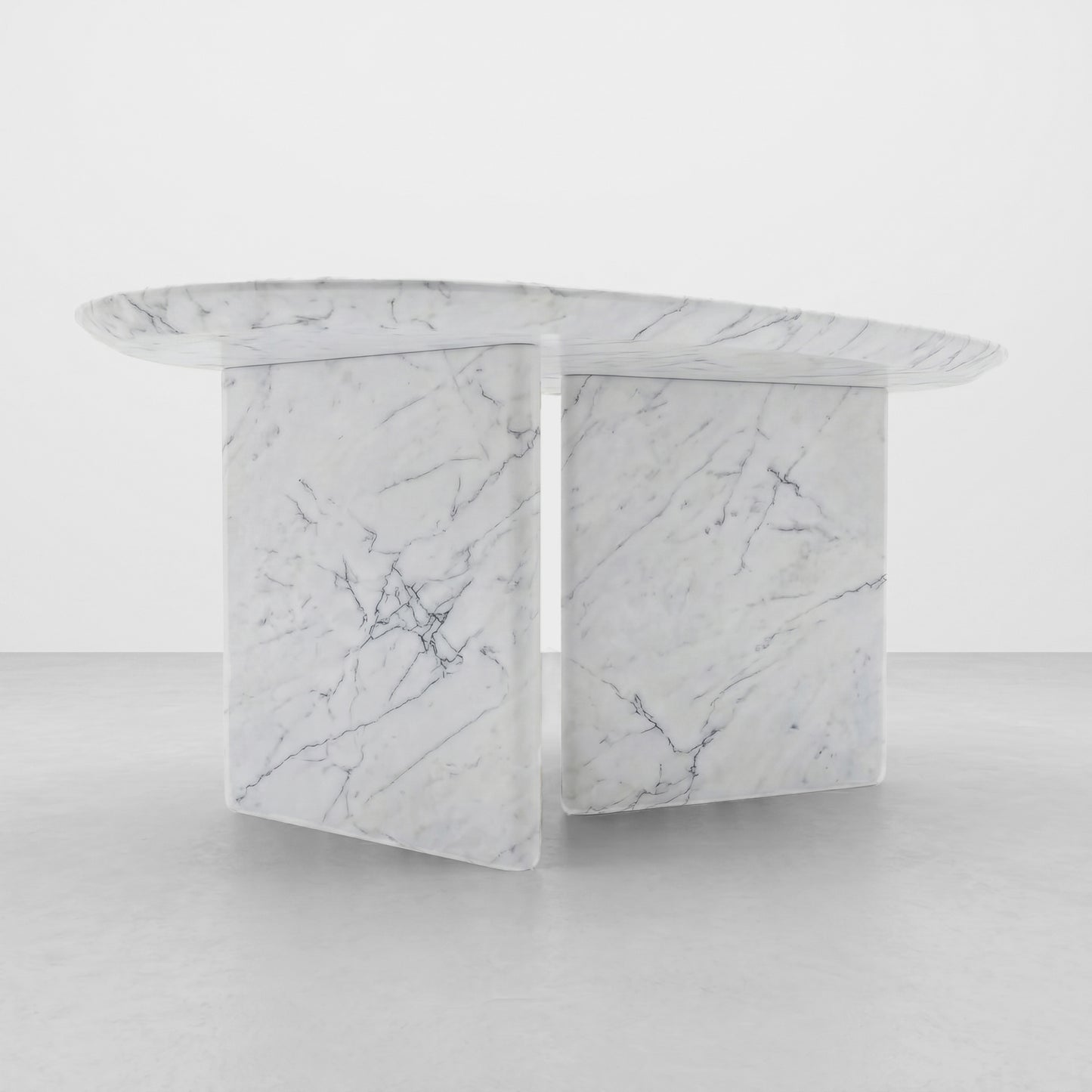 Detailed close-up of the subtle grey veining and polished finish of a White Carrara marble coffee table, showcasing the premium natural stone texture and smooth radiused edge.